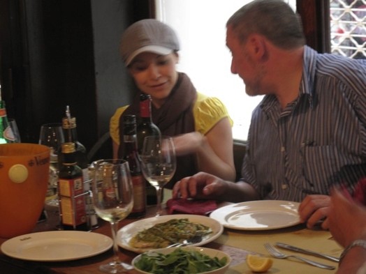 A photo of two people at a table in a restaurant.