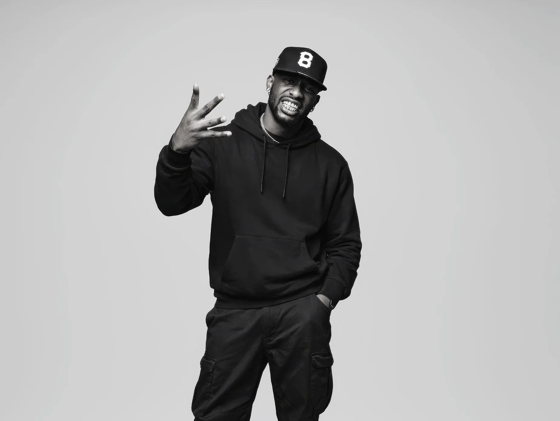 Studio portrait of London music artist Skayze Daze gesturing with his hand against a neutral background.