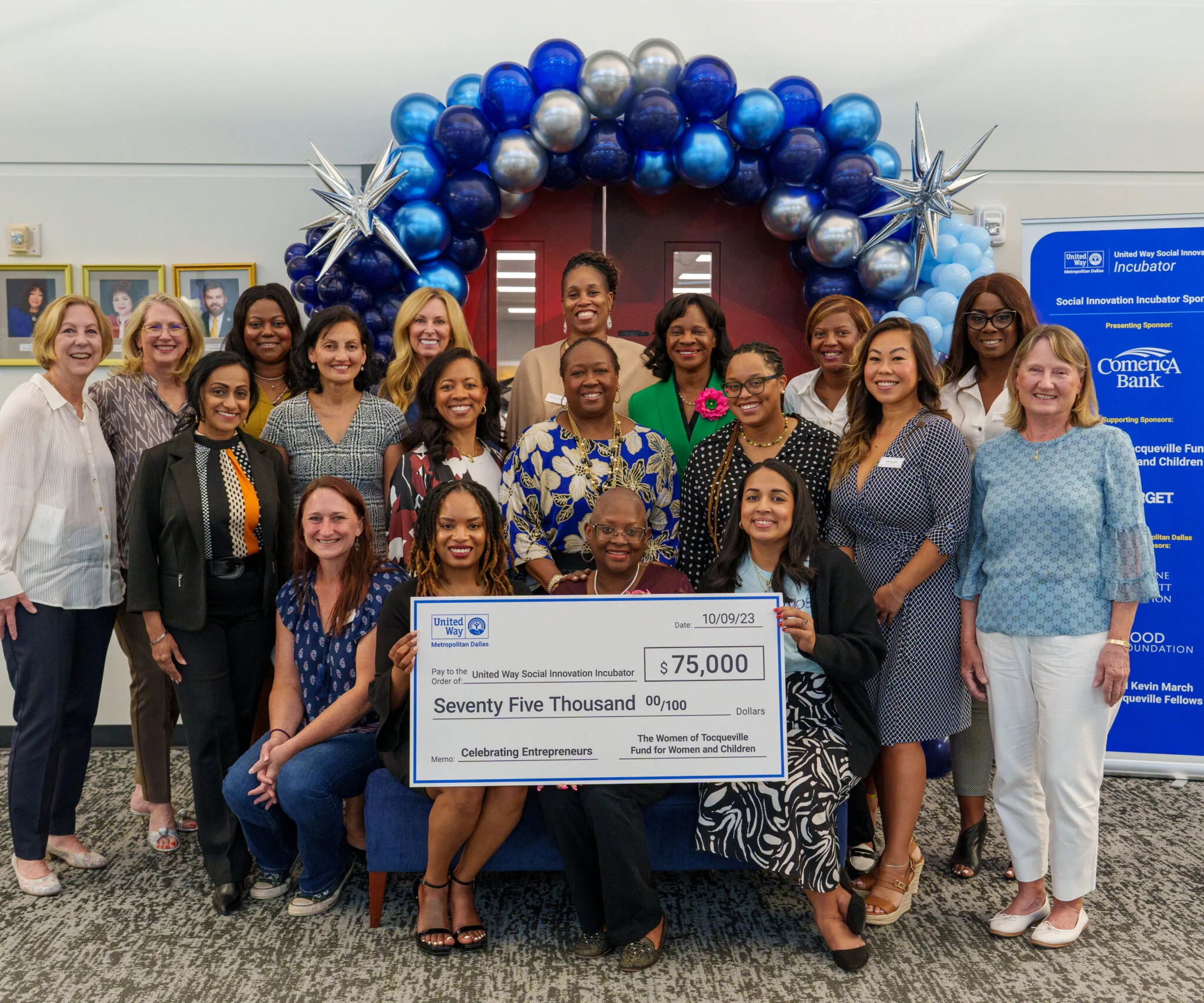 Cassandra McKinney with the United Way Social Innovation Incubator group, sponsored by Comerica Bank, accepting a $75,000 check for women entrepreneurs.