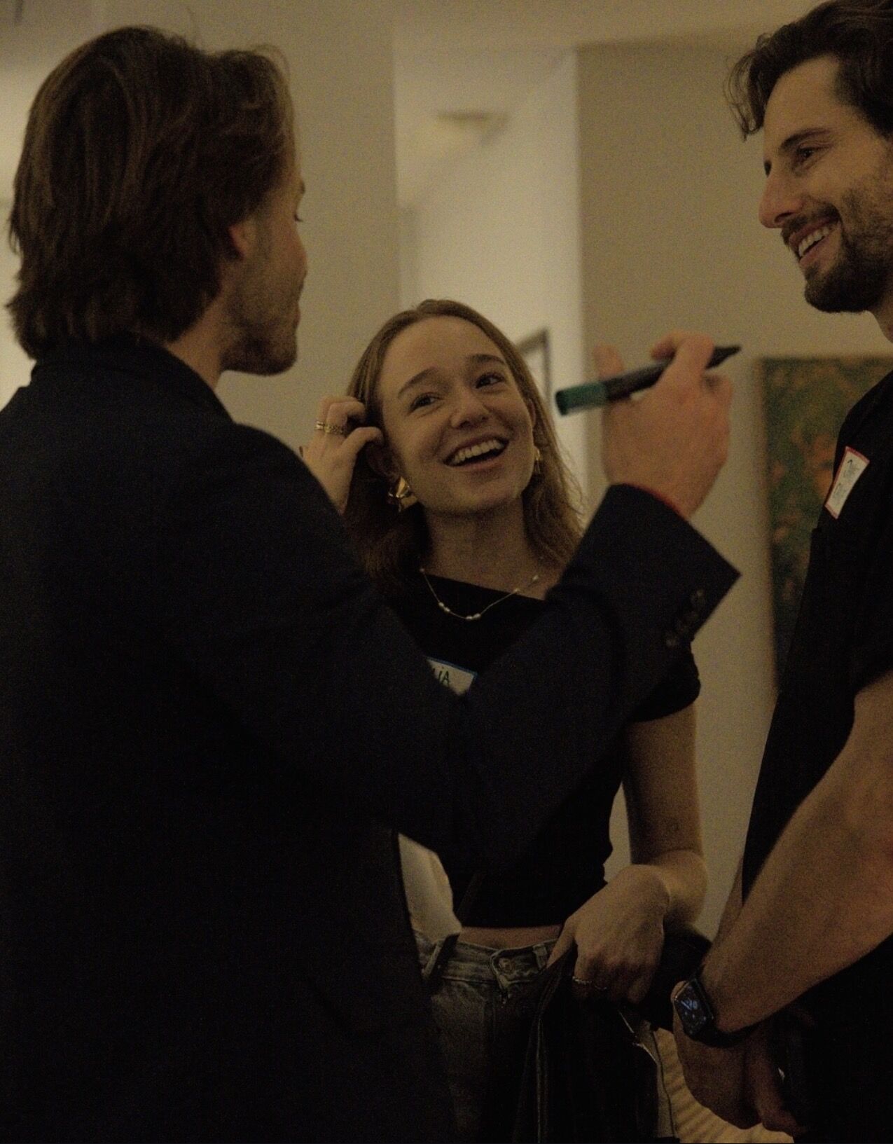 Woman practicing yoga in tree pose on a wooden deck overlooking misty mountain landscape at sunrise.