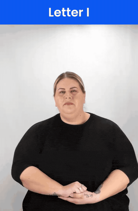 Animated GIF: a Deaf signer signs I in ASL, a fist with the little finger raised.