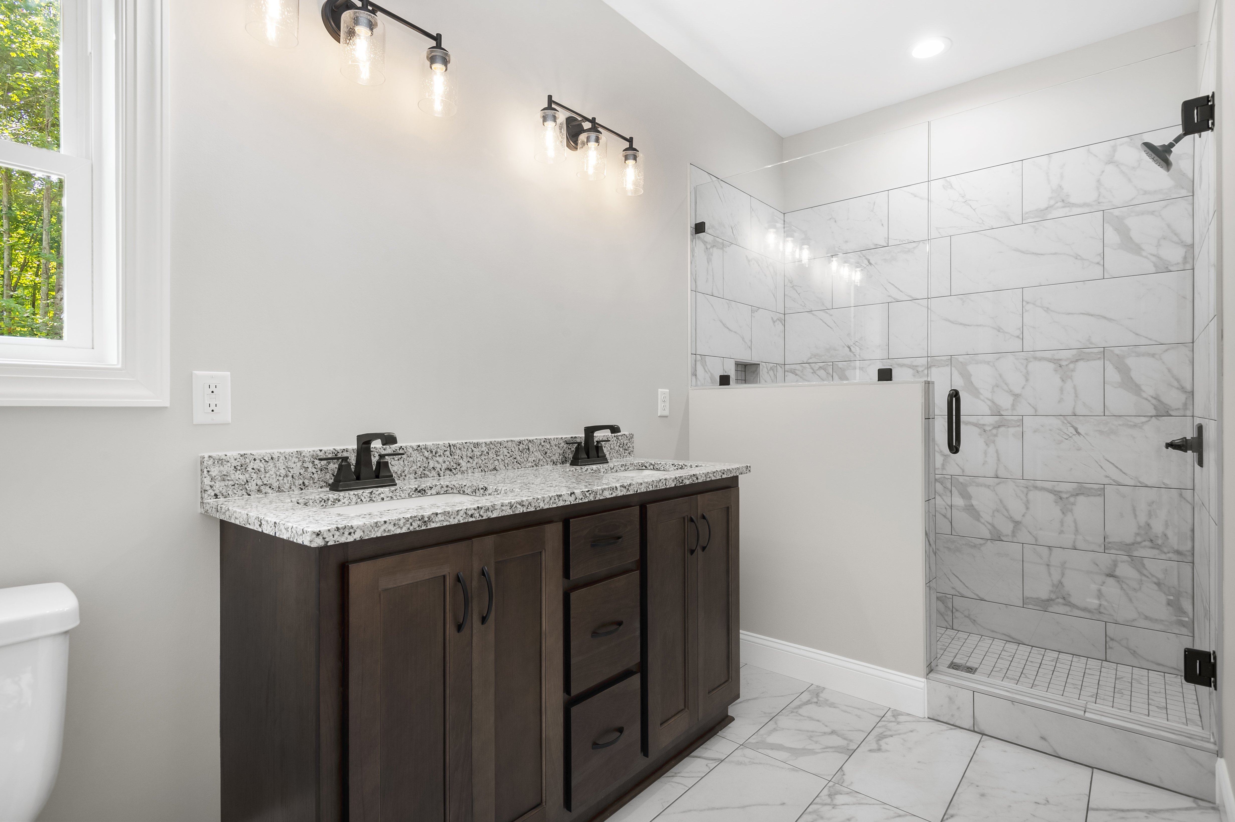 Open concept kitchen and living room with vaulted ceilings and hardwood floors