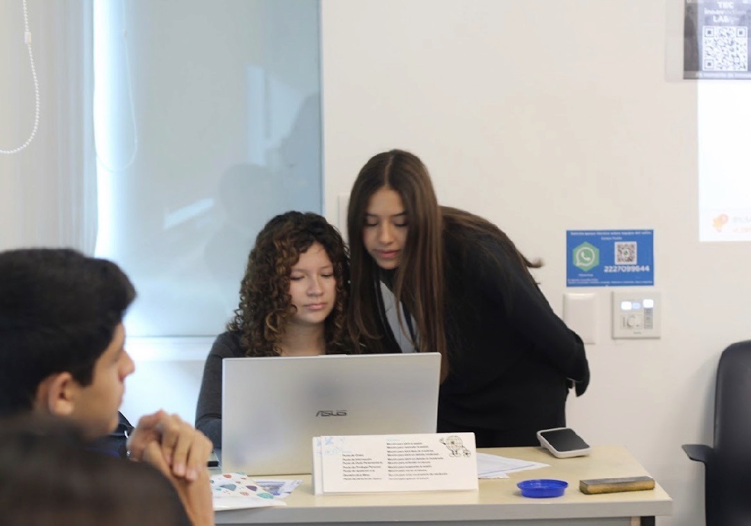Full moon rising over a dark, silhouetted mountain ridge.