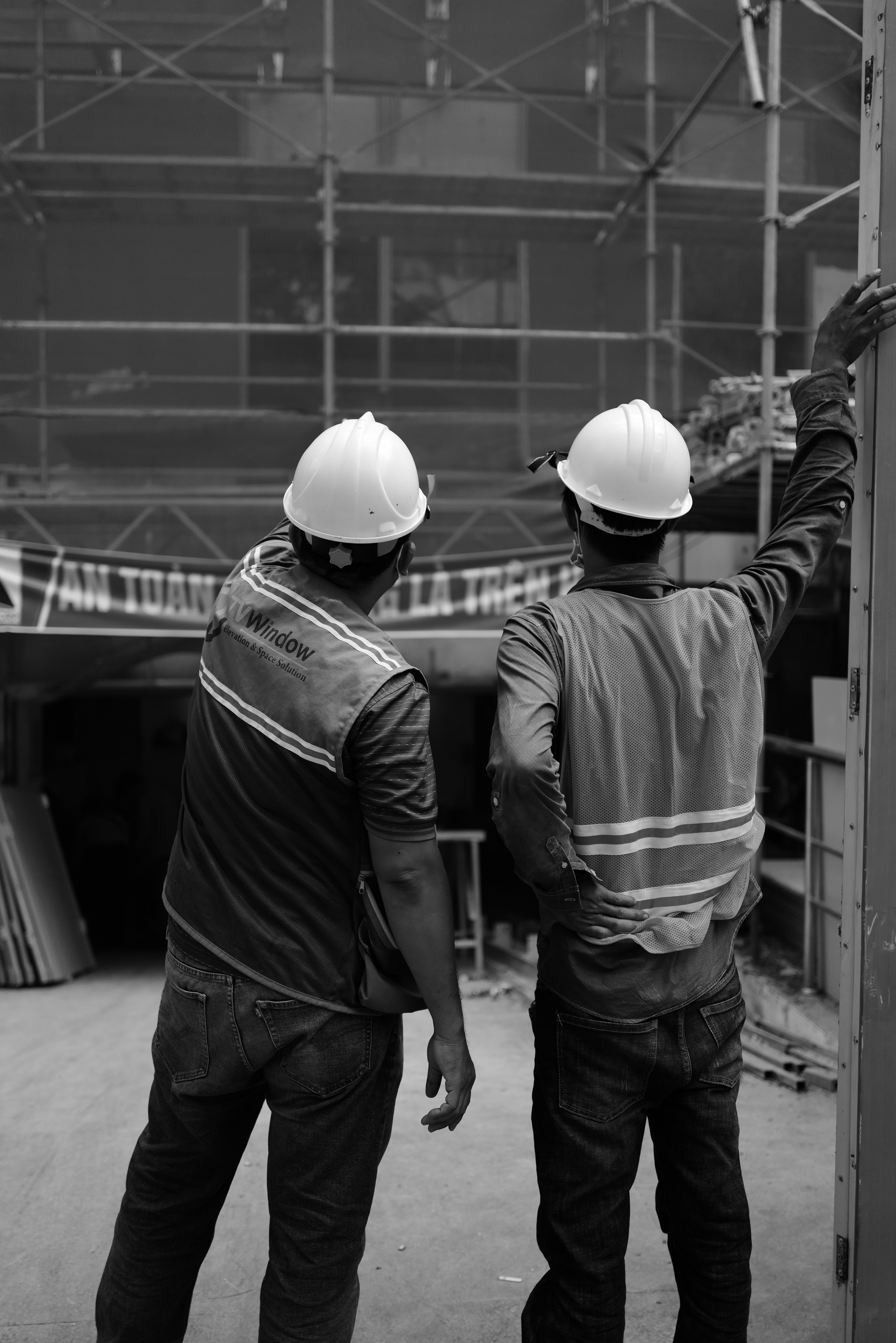 a couple of men wearing hard hats