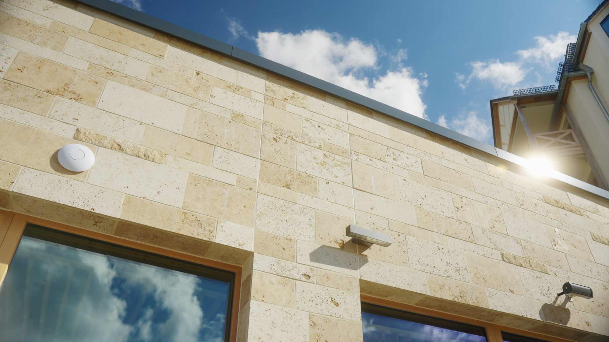 Sunlit stone building exterior captured with a drone for strategic film production, storytelling, and social media campaigns.