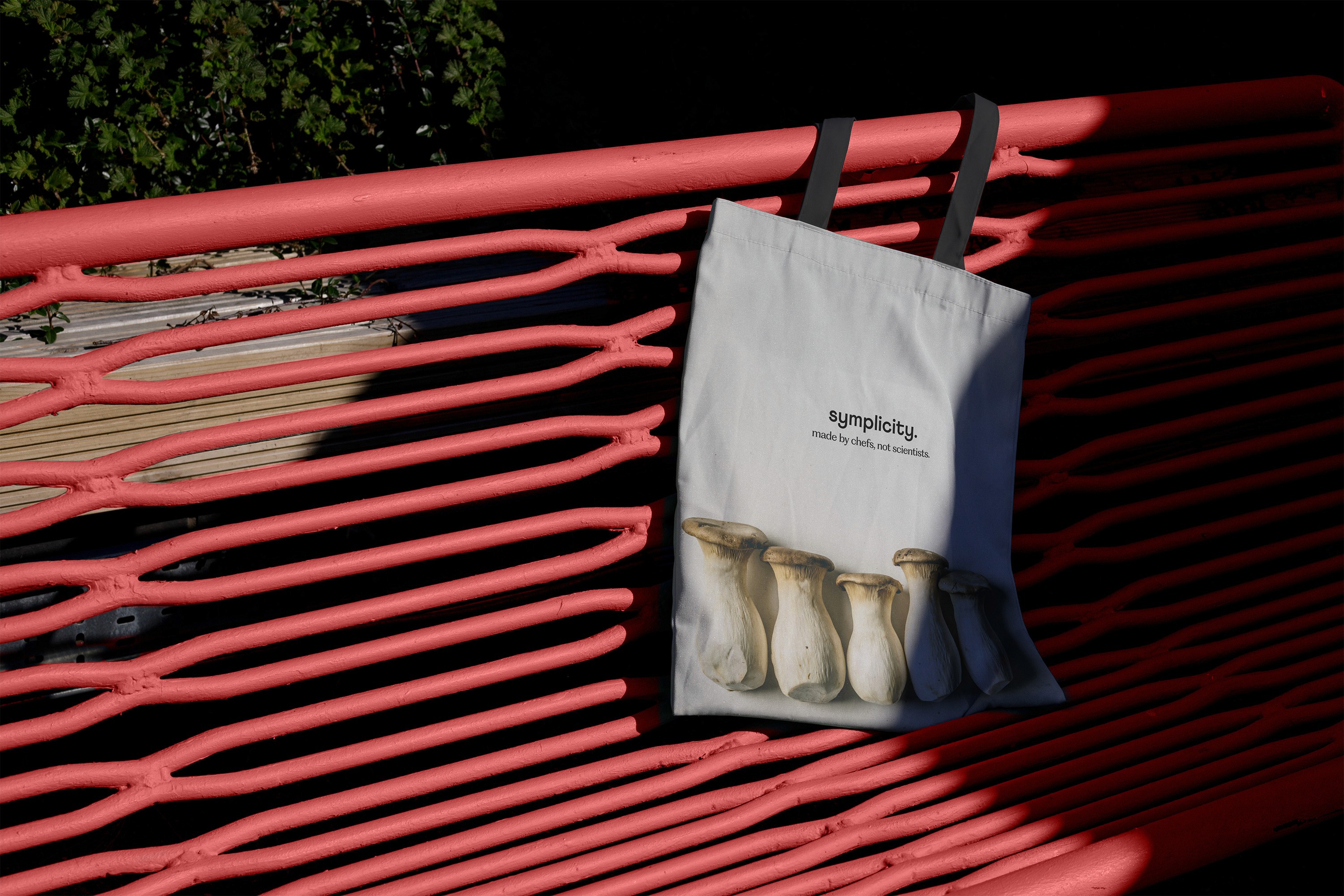 tipota design studio -Symplicity tote bag with mushroom background and symplicity logo — endline less is more -  symplicity branding