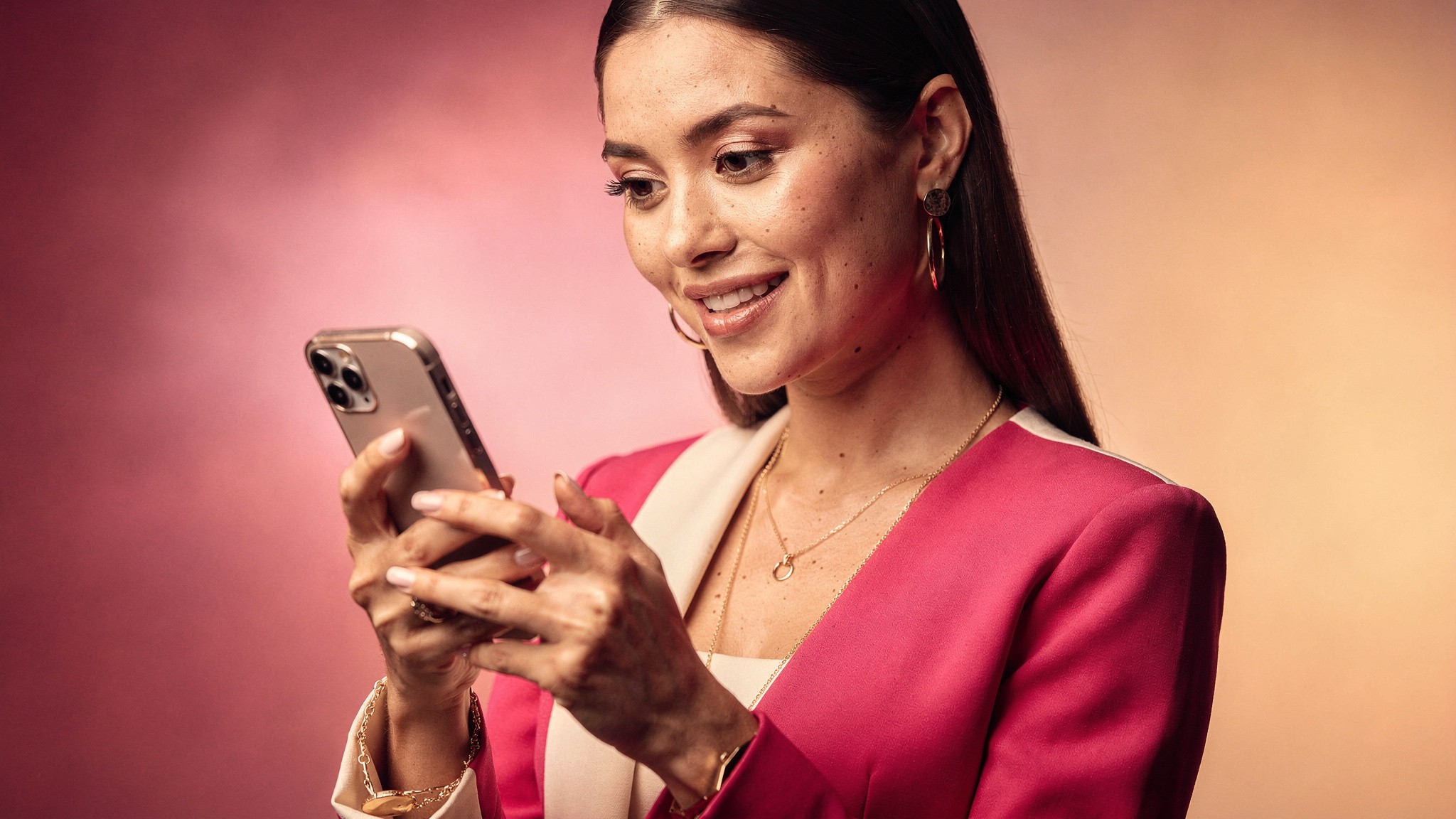Creator engaging warmly with her phone as if replying to comments