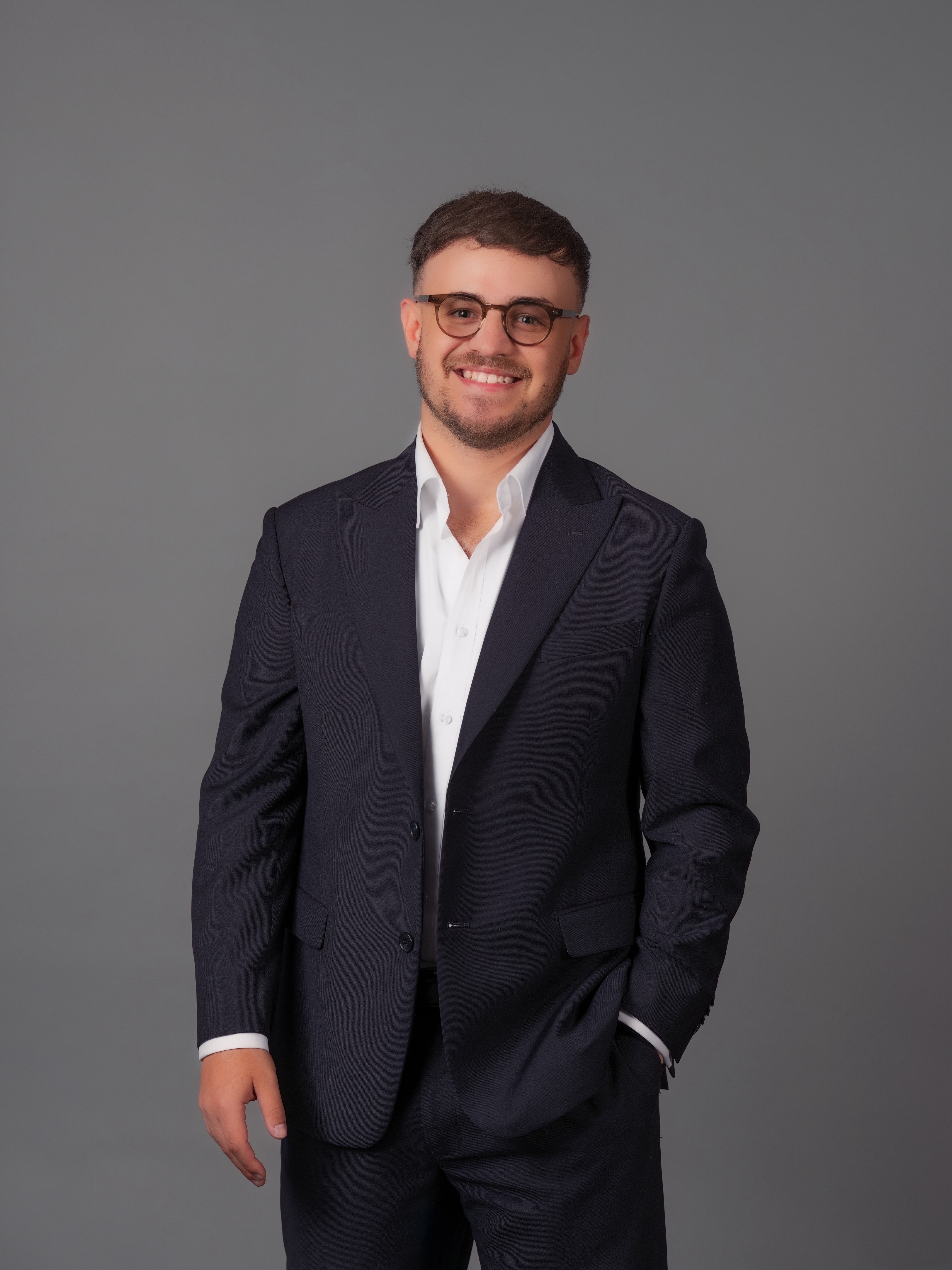 Jayden Vella, finance broker, posing on grey background in studio