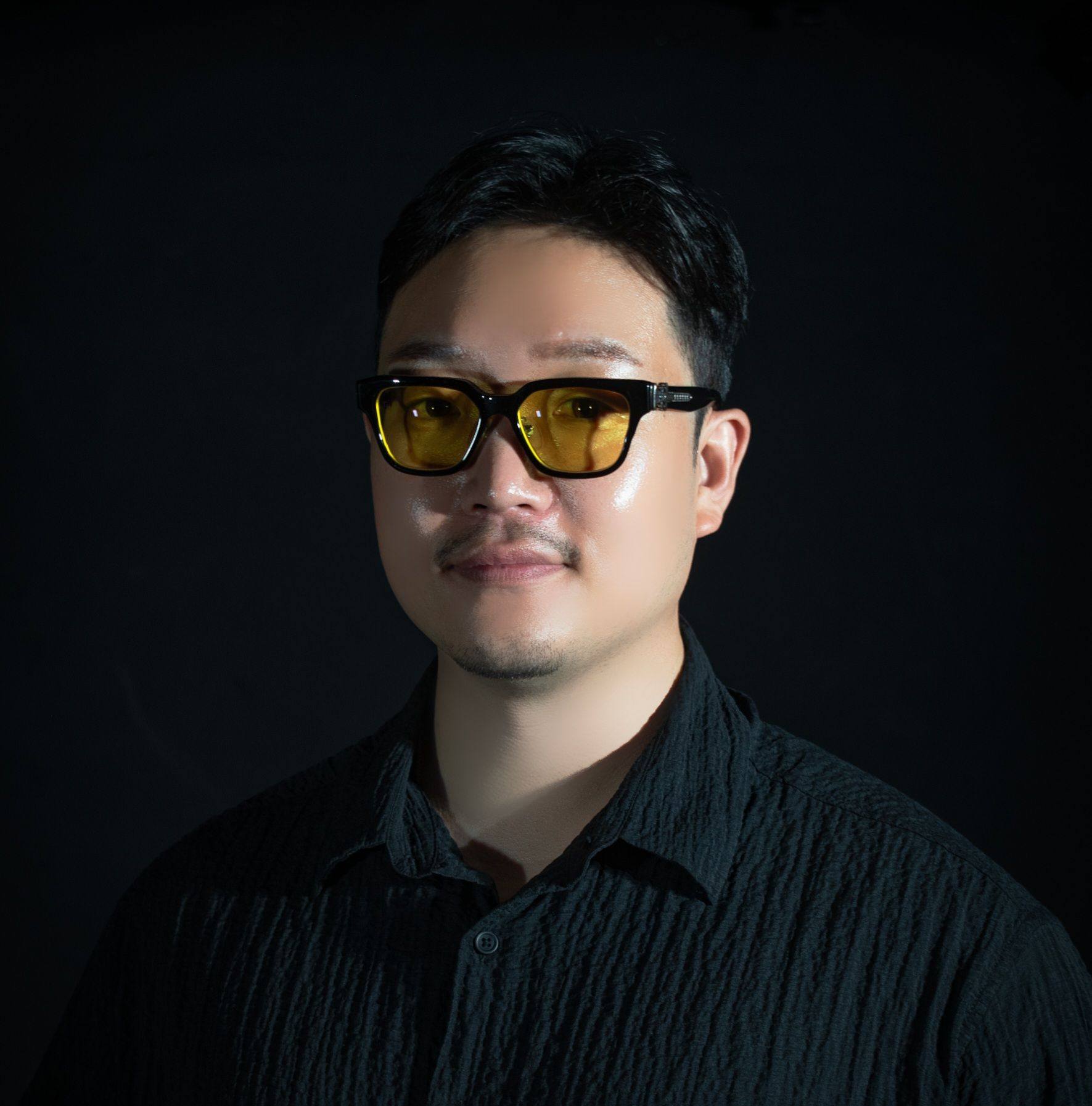 Profile portrait of a man in a white shirt against a light background