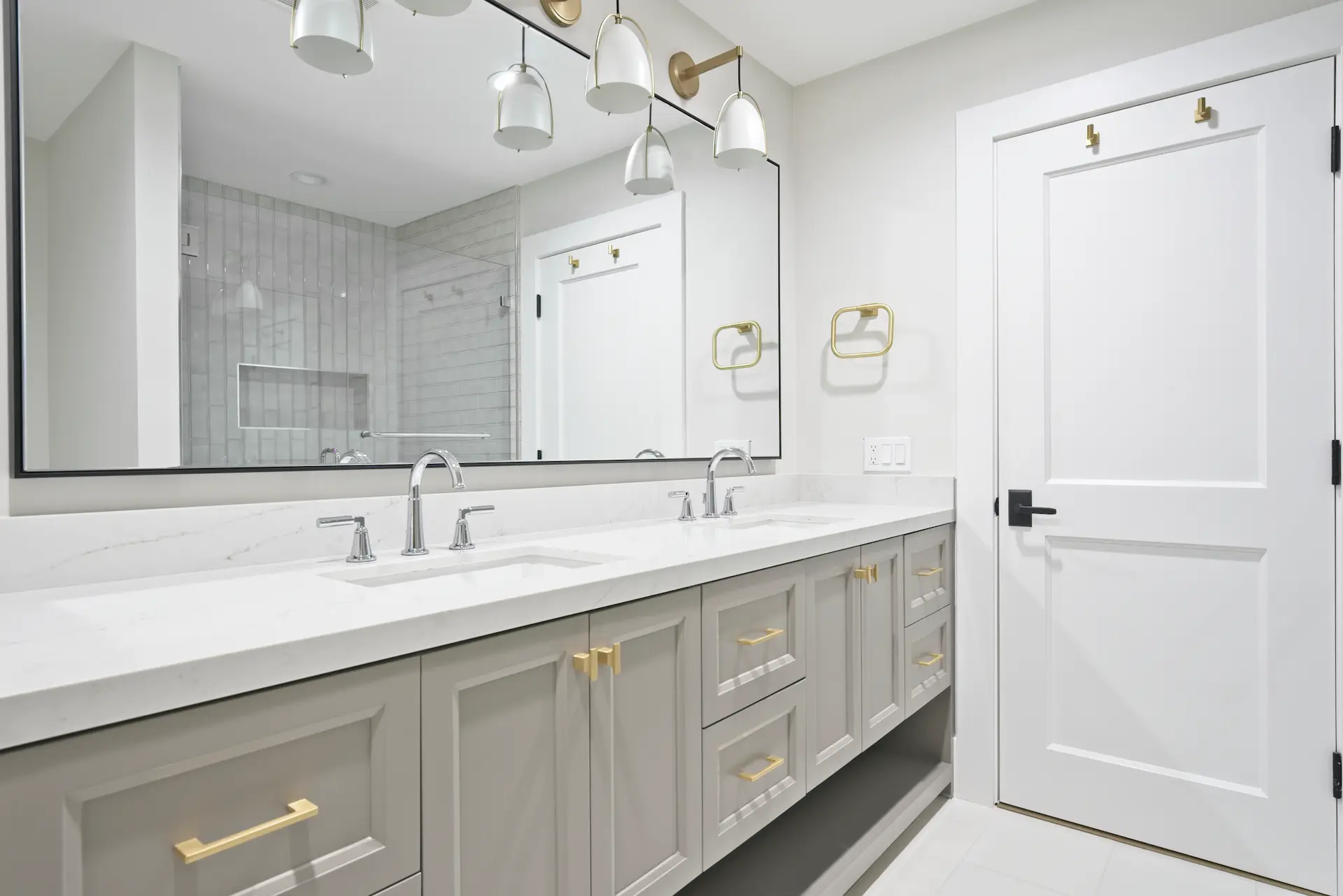 Wide view of the Jack and Jill bathroom's double vanity, reflecting practical elegance and cohesive design, perfect for shared spaces in the Dana Point Full Remodel. Photo by Todd Huge.