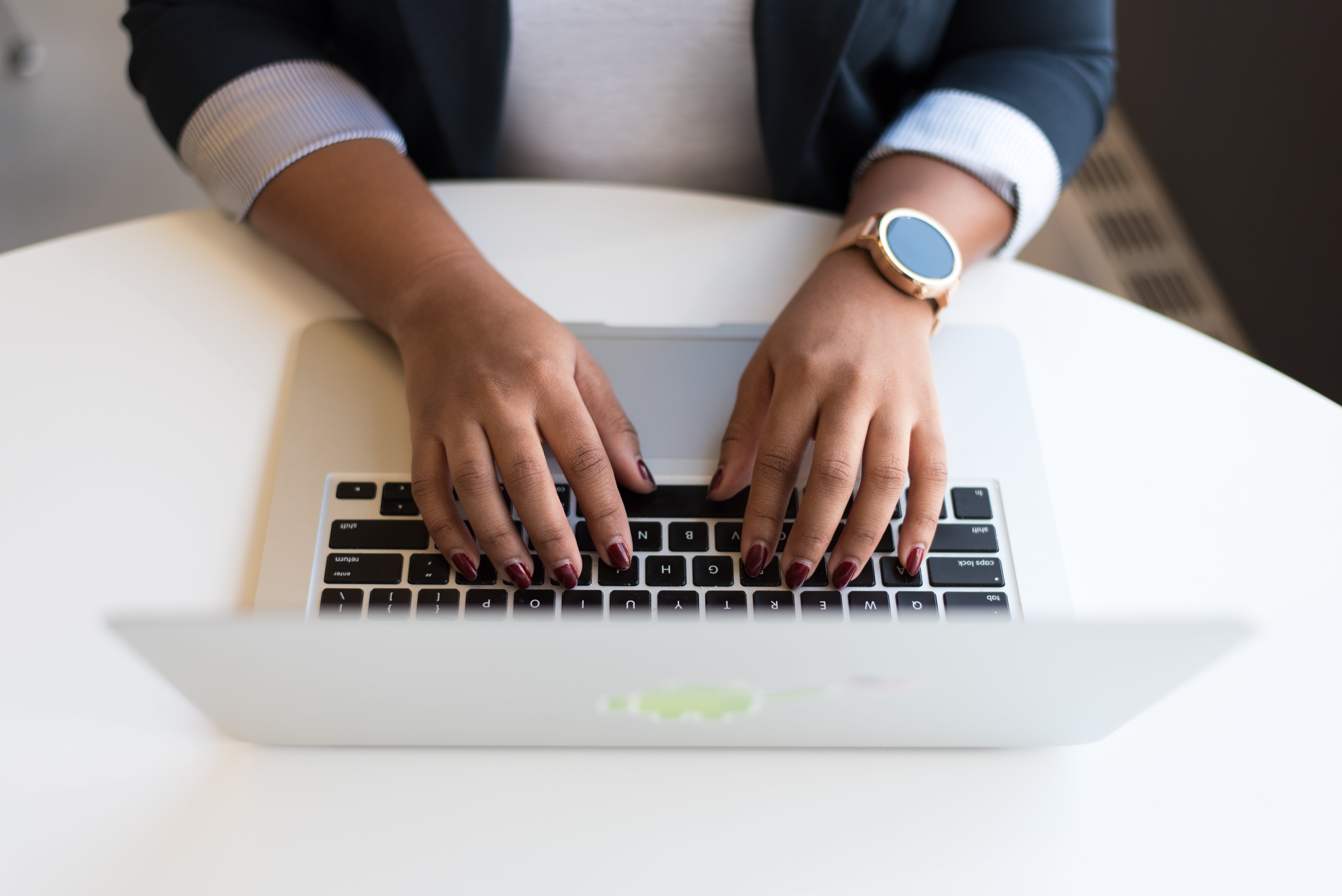 Person using macbook outlining key elements of an effective outreach plan