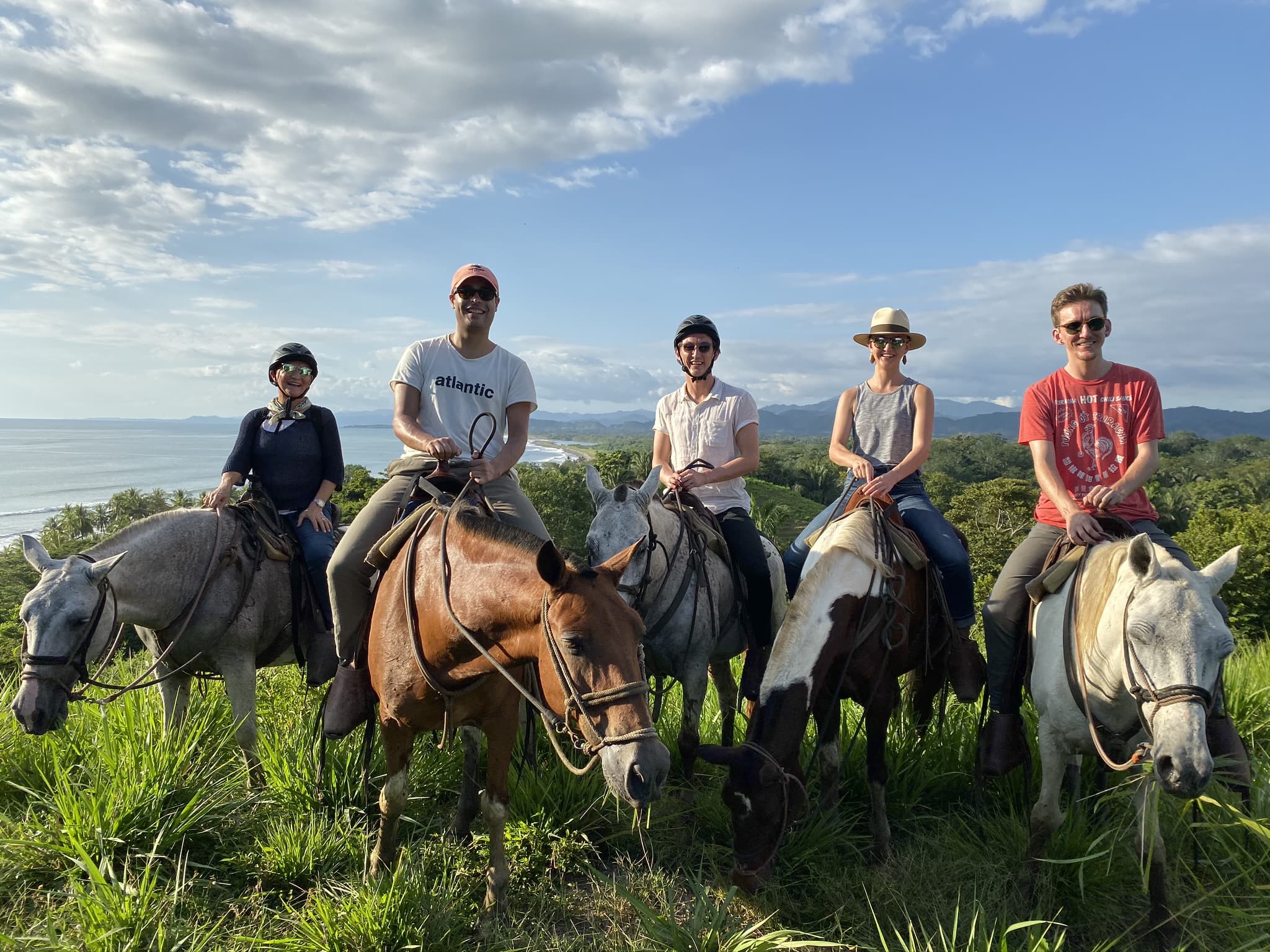 4 people on horses. Zach is 2nd from the right.