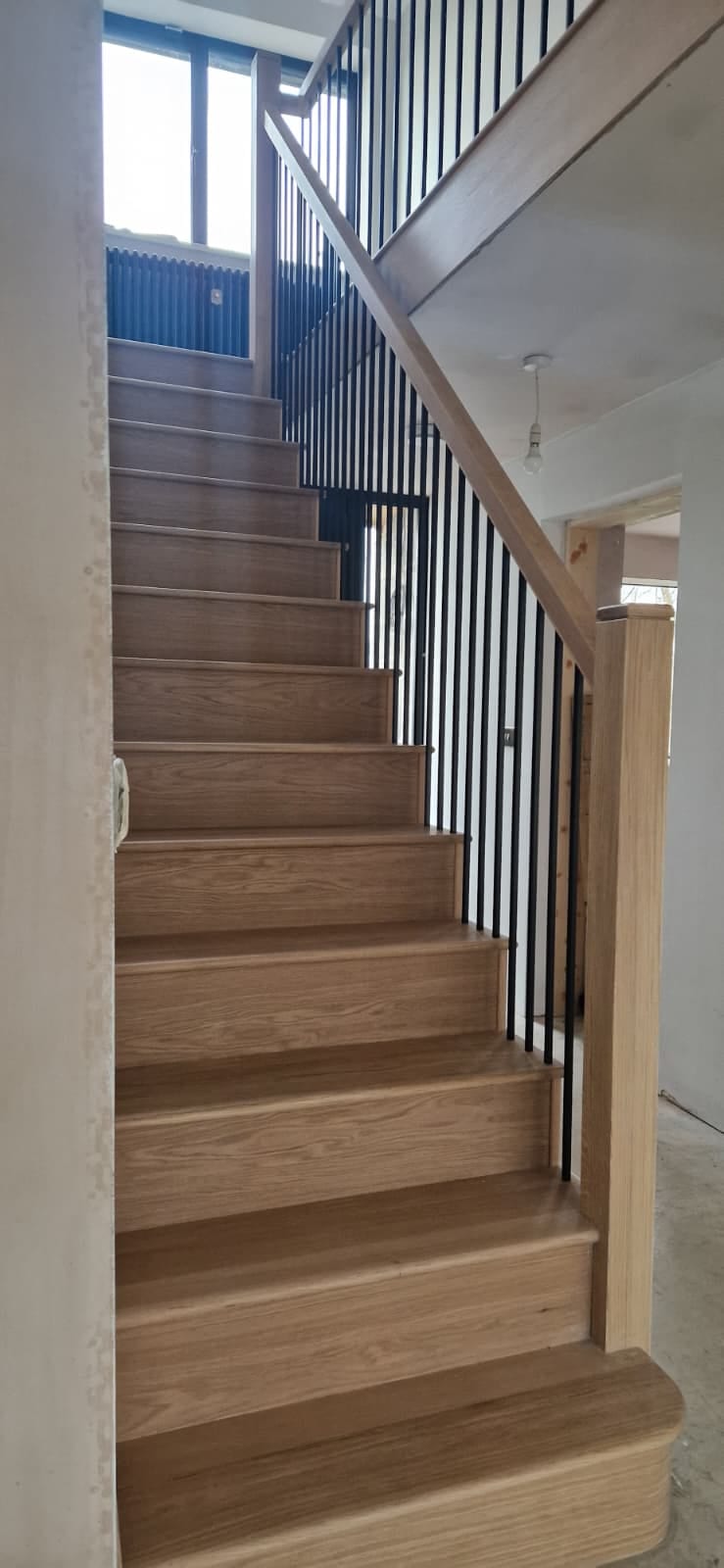 Oak treads and strings with black metal spindles