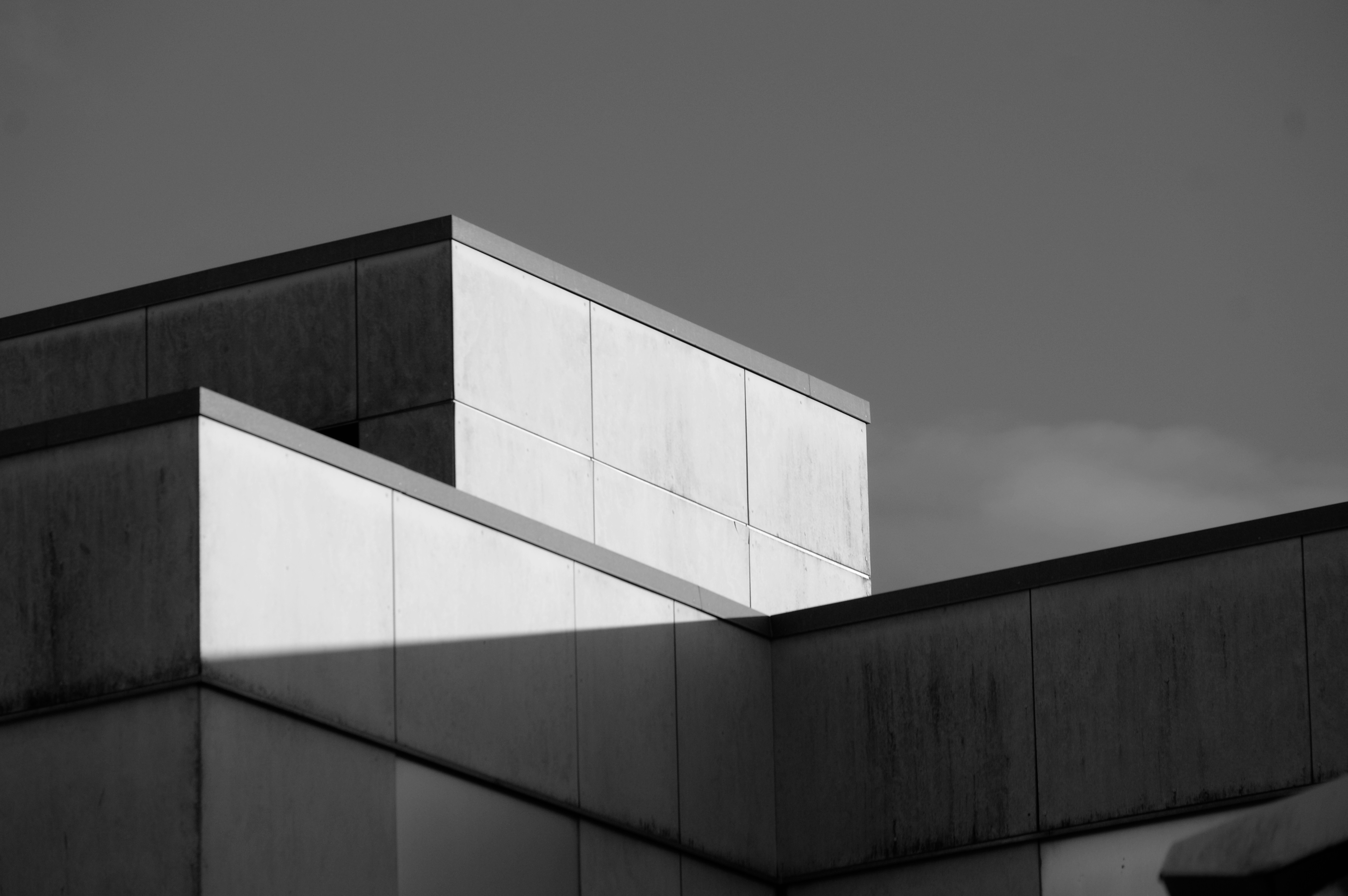 Geometric building facade with stark light and shadow