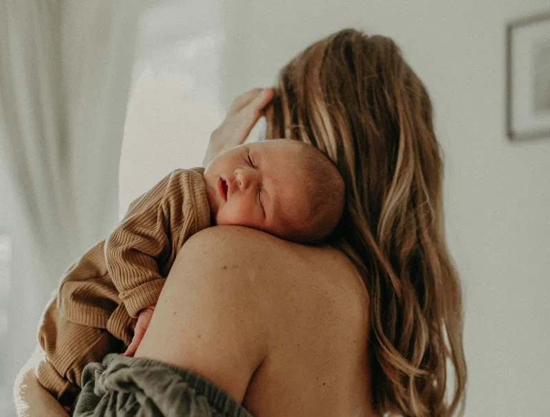 baby sleeping on mom