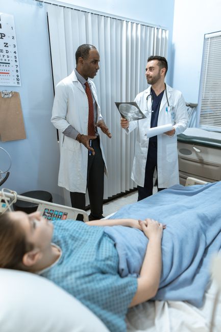 Clinician reviewing liver ultrasound and fibrosis results with metabolic lab markers for a lean MASLD evaluation