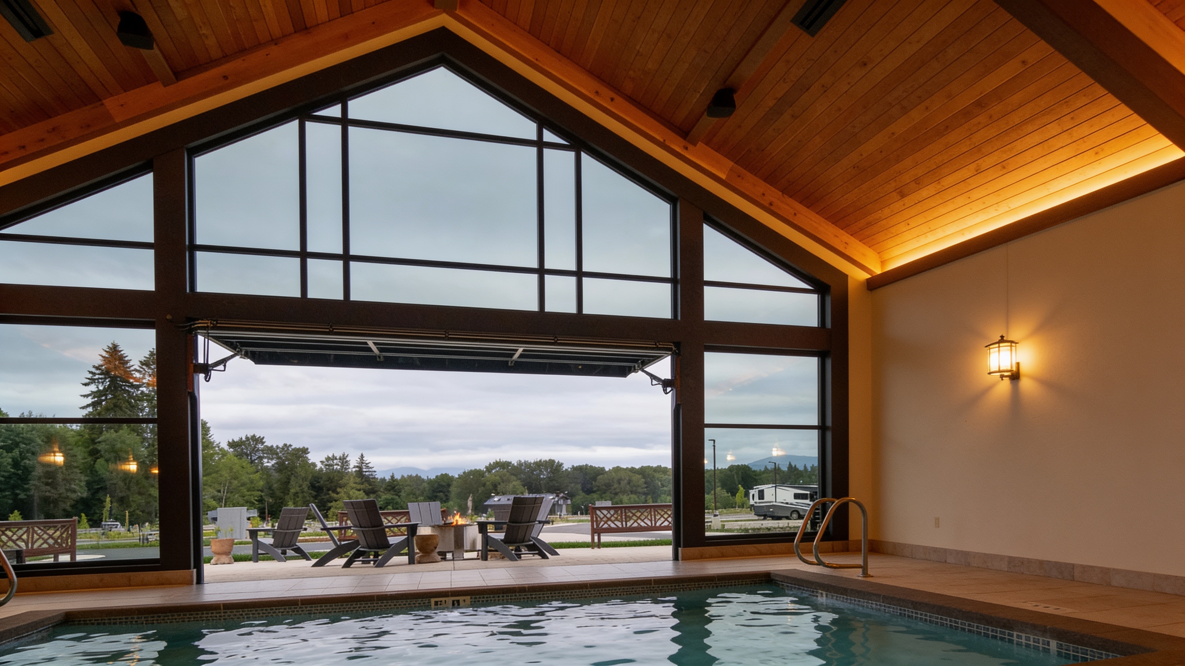 18-foot all-glass hydraulic architectural door over a resort indoor pool