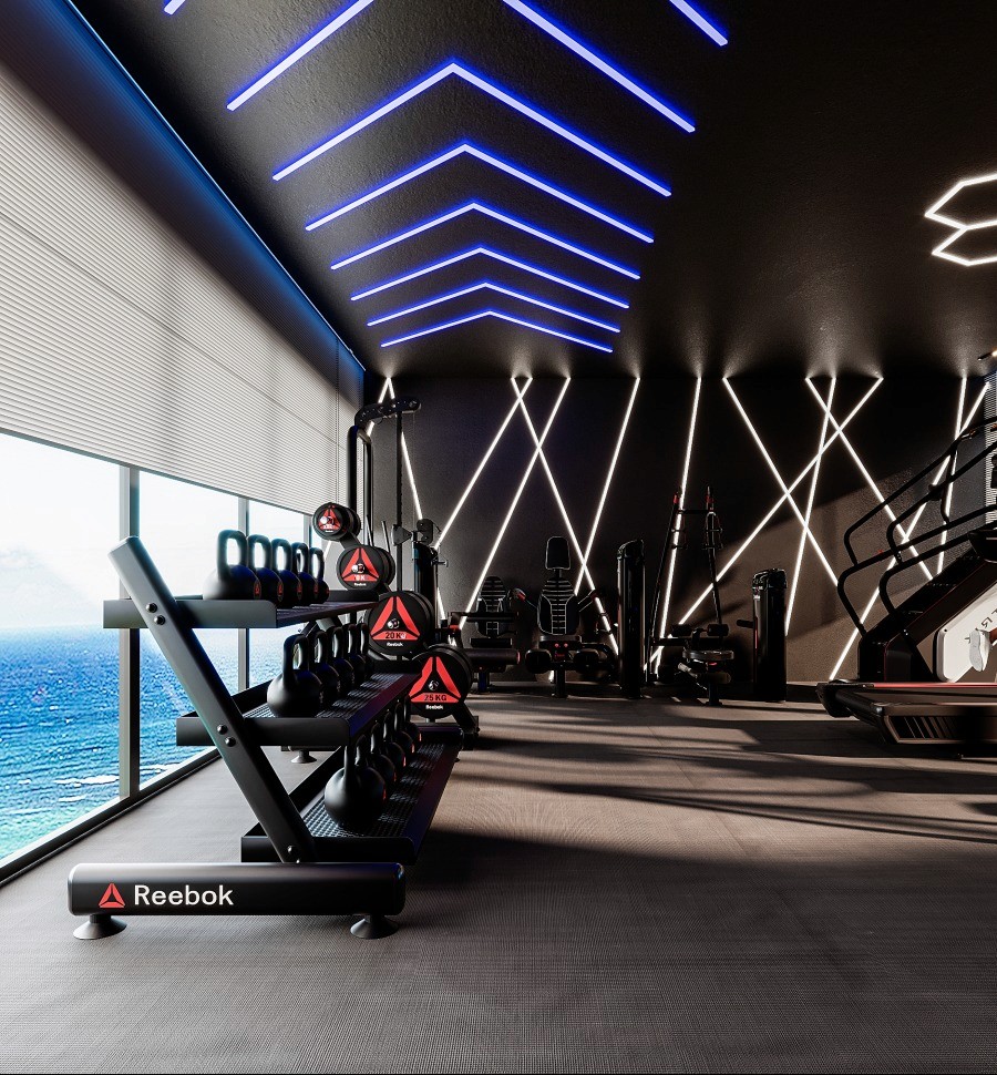 A gym room featuring large windows that offer a stunning view of the ocean