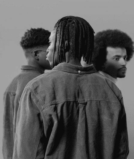 photo of three men seen from behind or the side