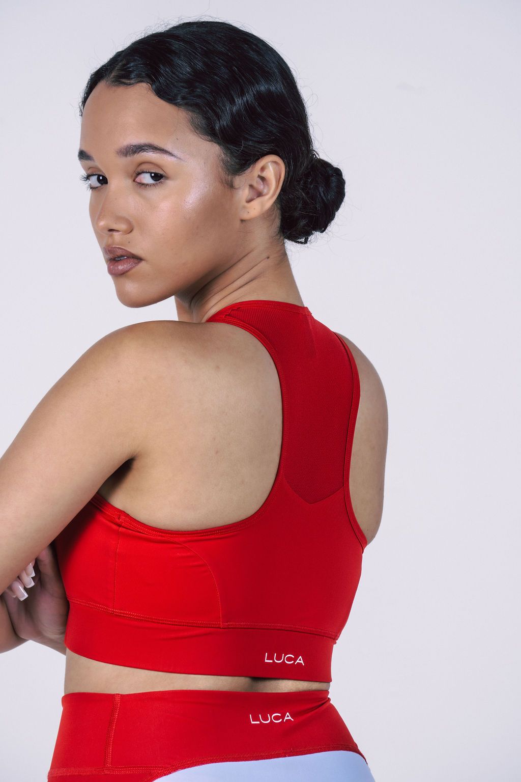 Red-high-support-sports-bra- featuring-a-mesh-racerback-panel- and-LUCA-logo-print-on-the-band- for-high-intensity-workouts