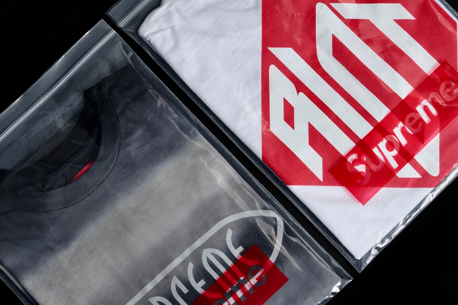 A person wearing a green jacket with a large red diamond-shaped logo that reads "RIOT" on the back.