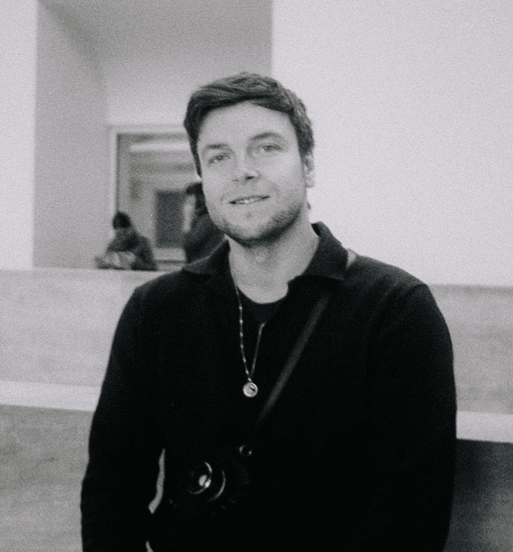 Man wearing white bunny hat with fake glasses and mustache design.