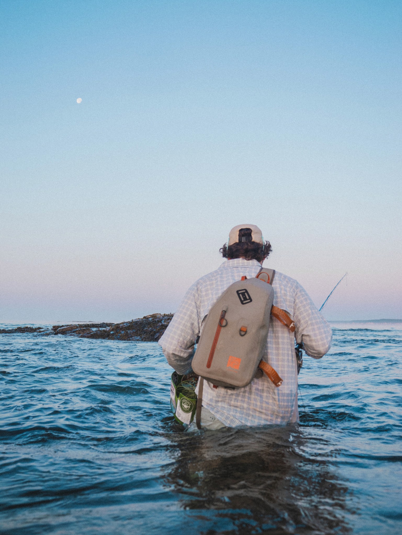 Brand identity for Twelve Weight shown in use while fly fishing in open water