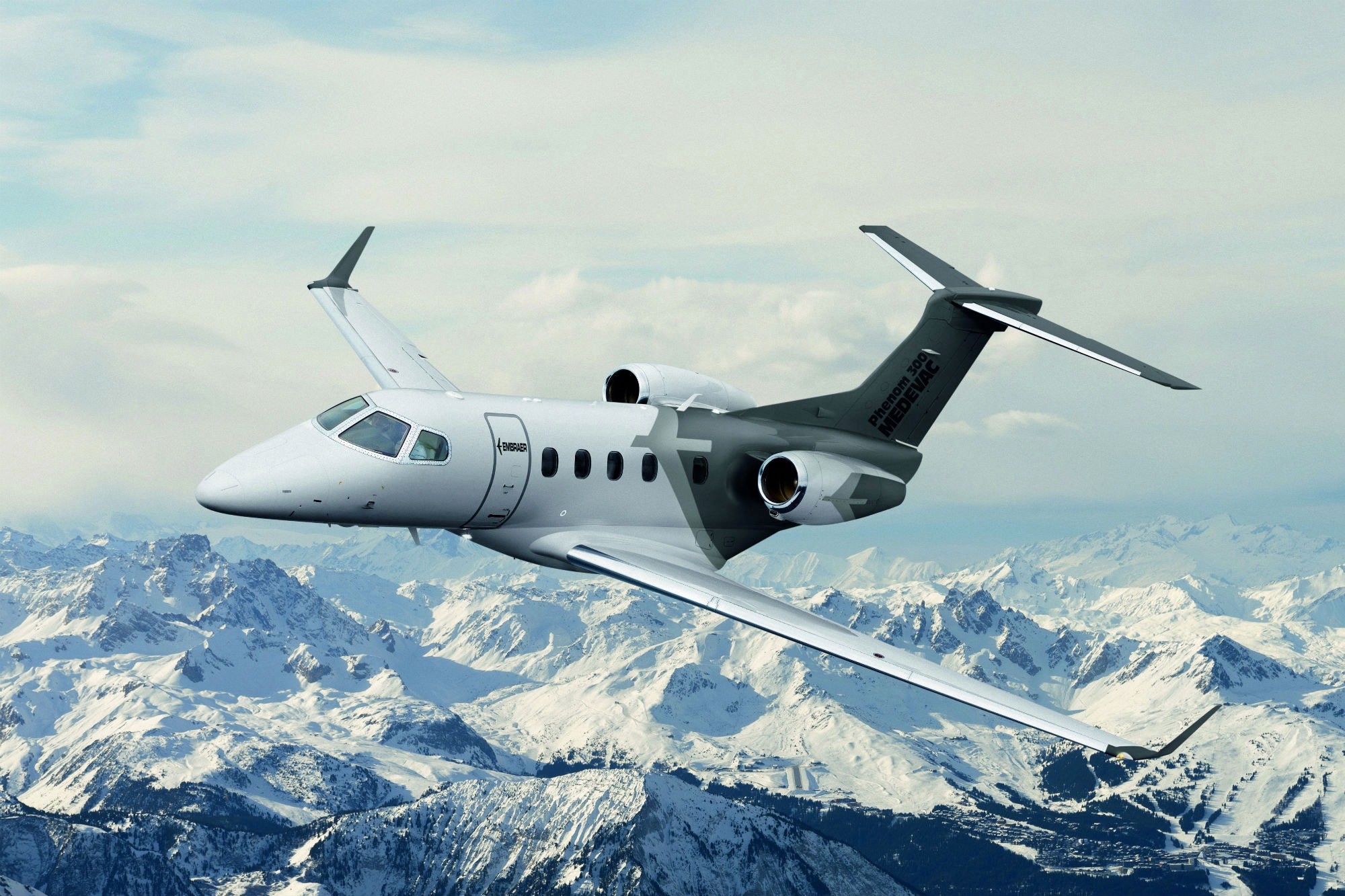 The Embraer Phenom 300E is a light business jet that can seat up to 10 passengers. It is an upgraded version of the Phenom 300, featuring a range increase of 70 nautical miles, a quieter cabin, and avionics upgrades.     The Phenom 300E is powered by two Pratt & Whitney Canada PW535E1 engines, each producing 3,478 pounds of thrust. The maximum cruise speed is Mach 0.80, and the maximum range is 2,010 nautical miles with NBAA IFR reserves.     The cabin features a flat floor, six large windows, and a generous baggage compartment with 84 cubic feet of space. The interior can be customized to meet individual preferences and is available in a variety of configurations, including a refreshment centre, lavatory, and various seating arrangements.     The cockpit is equipped with the advanced Prodigy Touch flight deck, which includes large displays, intuitive touch-screen technology, and advanced automation features. Other safety features include a digital flight control system, auto-throttle, and enhanced situational awareness technology.     Overall, the Phenom 300E is a popular choice among business jet owners and operators for its combination of performance, comfort, and safety features.   