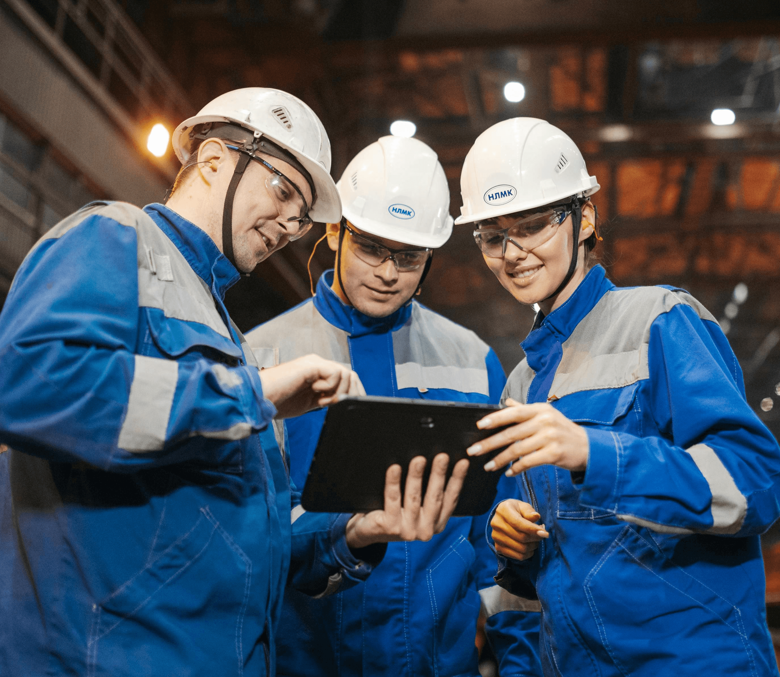 The workers are looking at the work plan on the tablet.