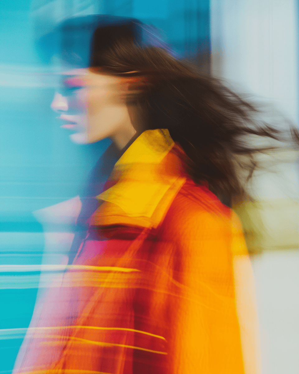 Motion portrait of techno artist under warm stage lighting.