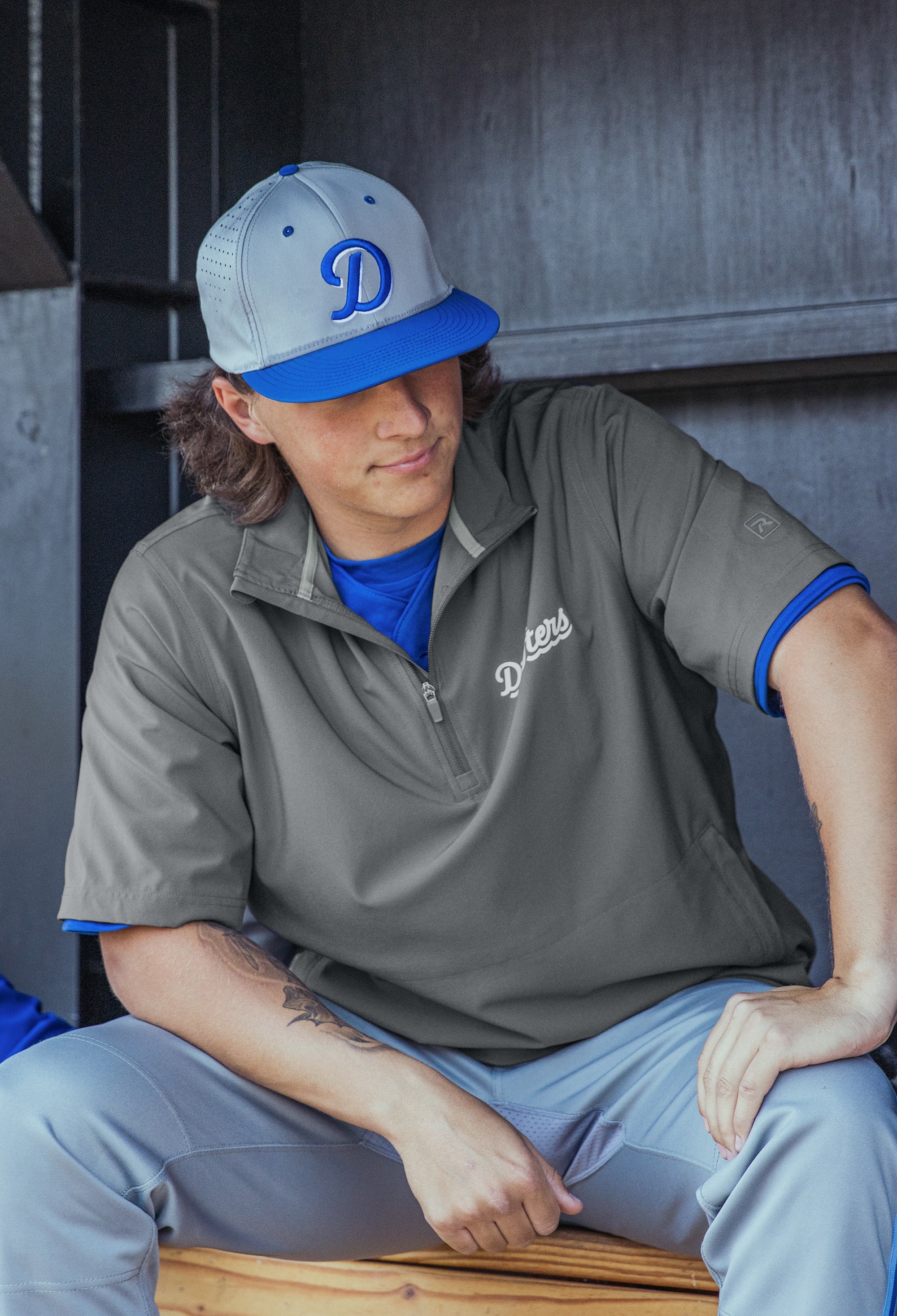 man in black and white hoodie wearing white cap