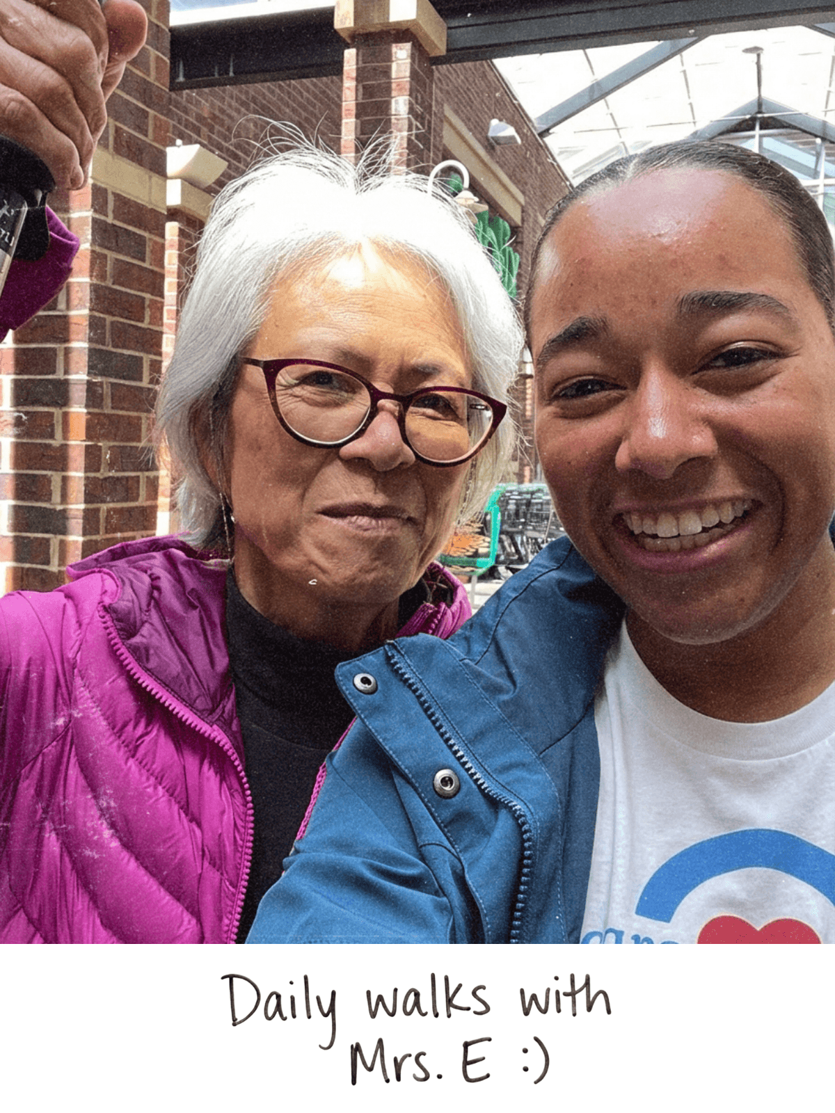 Polaroid selfie of CareYaya student and older adult woman on a walk