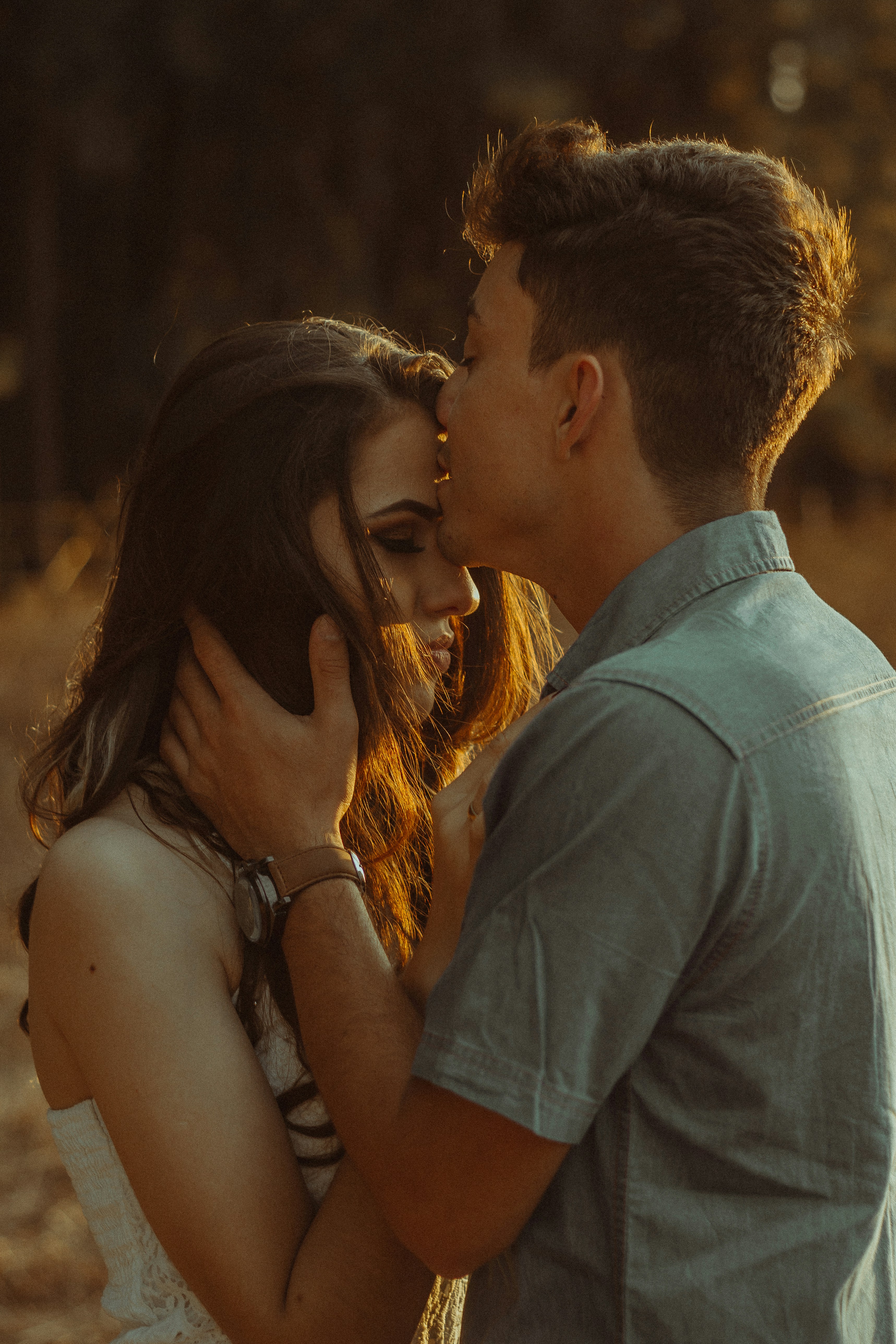 boyfriend kissing his girlfriend on forehead