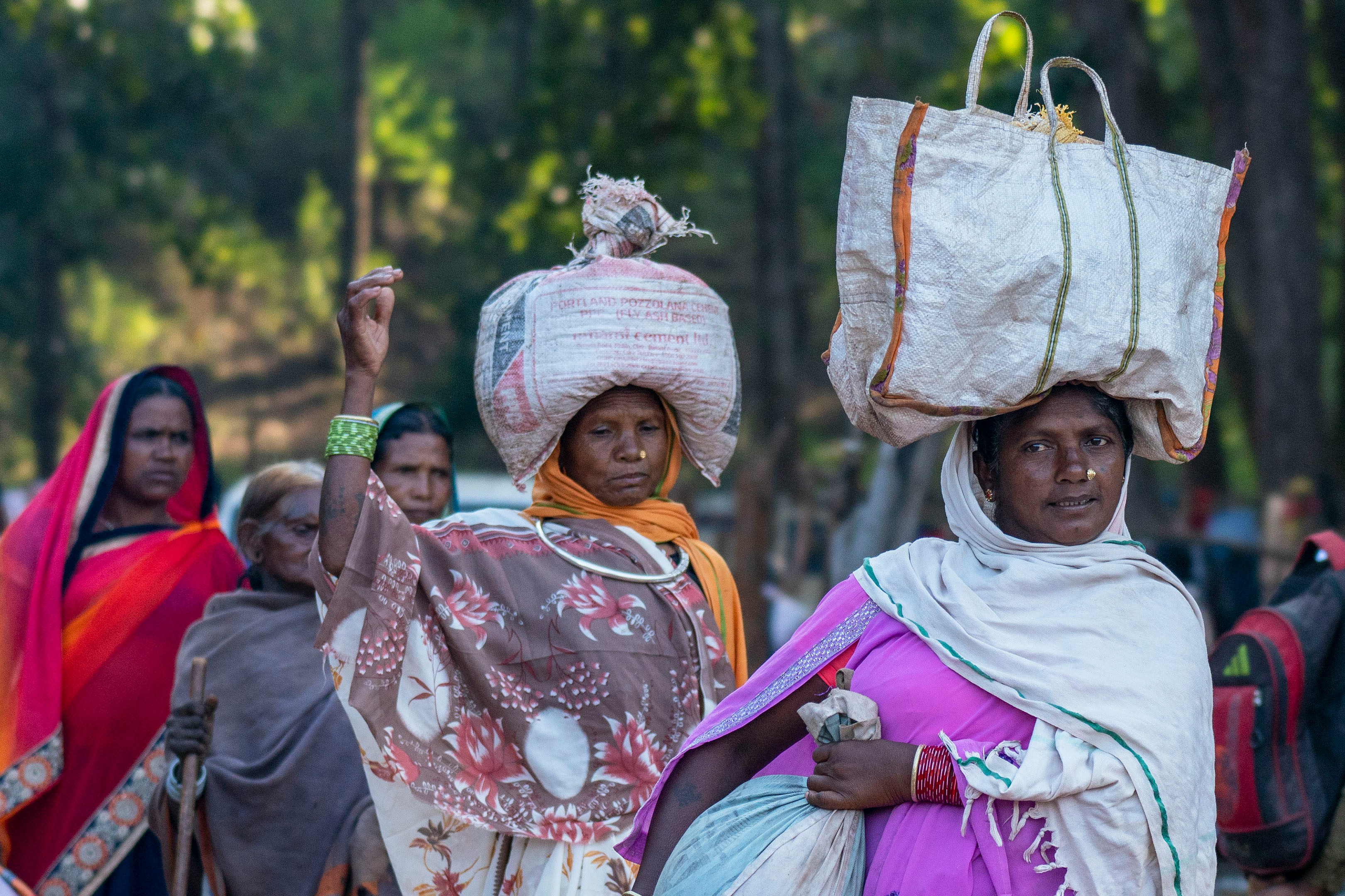 A group of women carrying bags on their heads