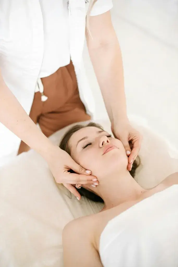 Aesthetician performing facial massage during an anti-aging treatment to lift and tone the skin, promoting firmness and improved elasticity.