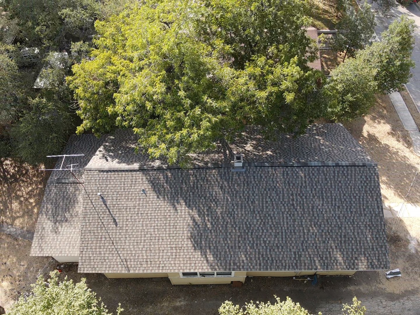 Gable roof featuring Harvest Blend GAF shingles with a ridge vent for improved ventilation and a warm, natural aesthetic.