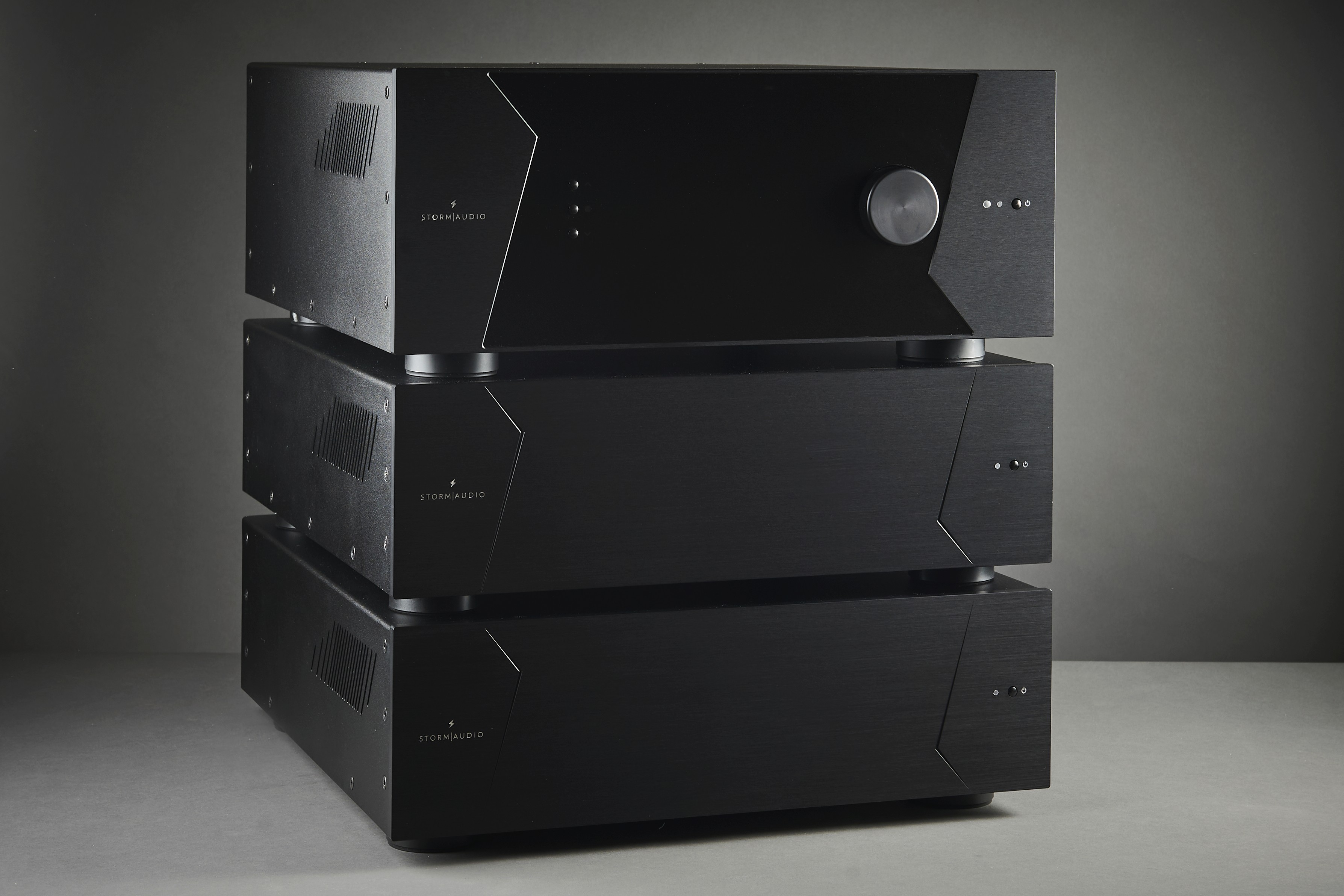 Three black audio components stacked