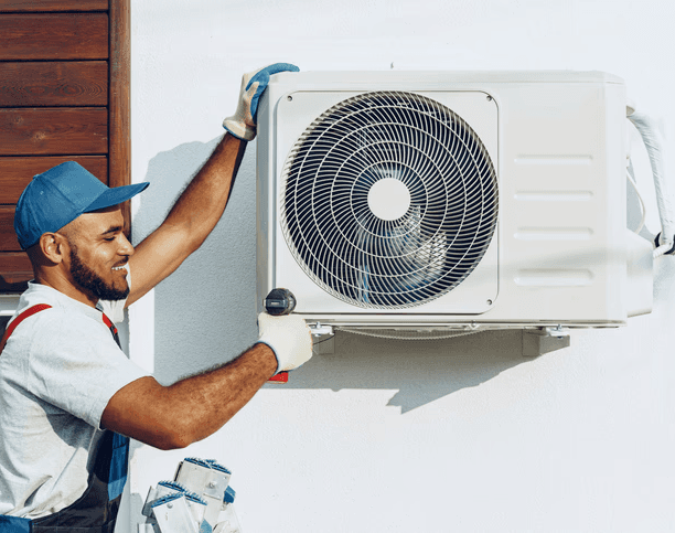 HVAC technician installing an outdoor AC unit for a cooling system in a Toronto home