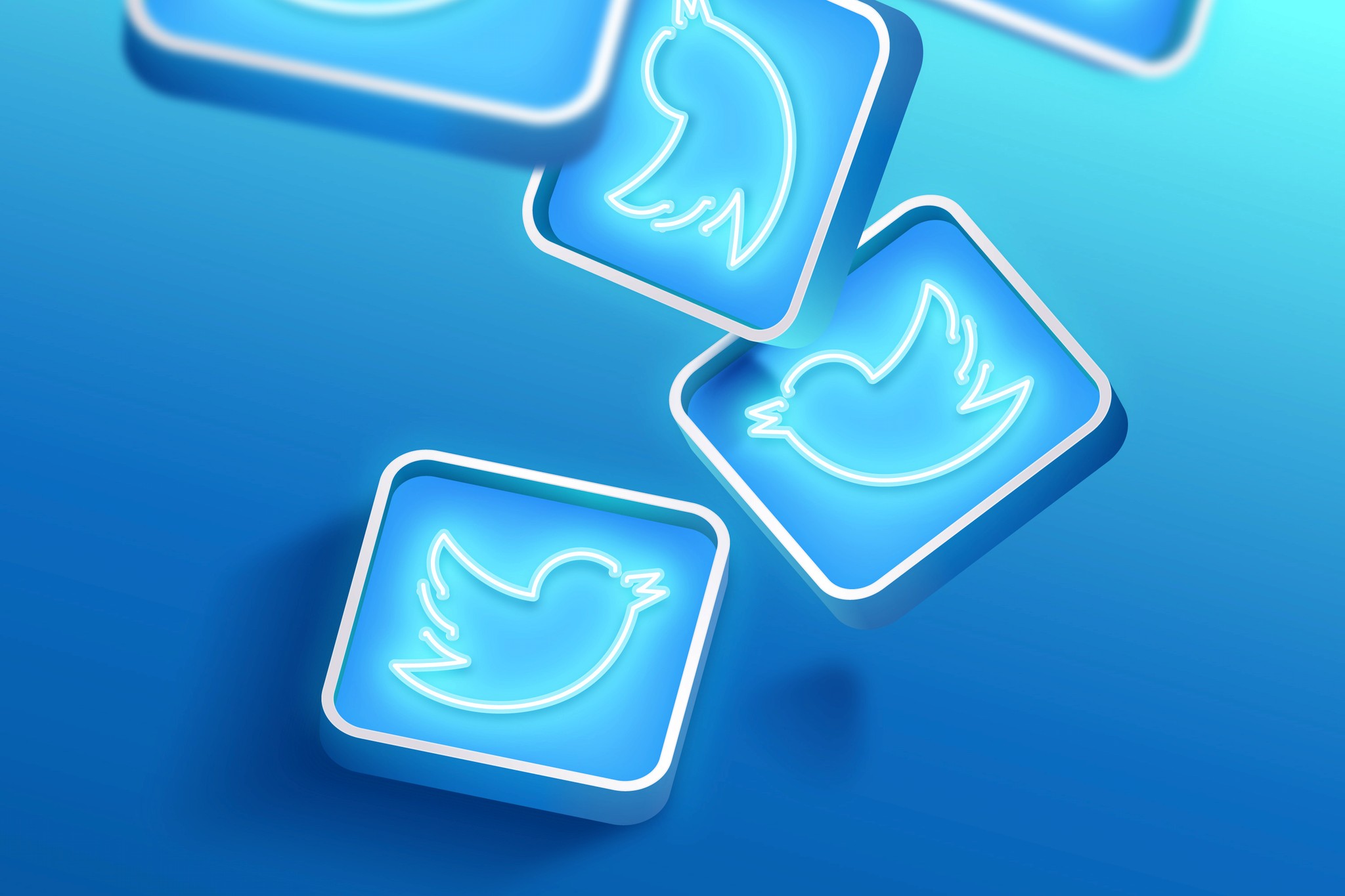 Twitter icons displayed on a vibrant blue background, symbolizing social media connectivity and engagement.