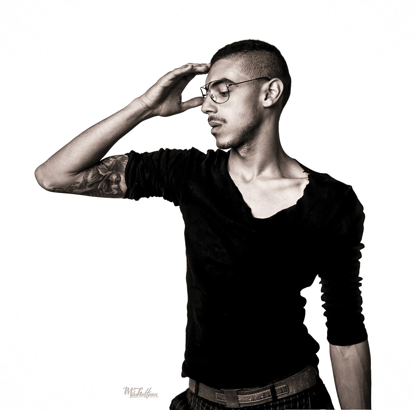 Studio portrait in black and white with a focus on sharp facial detail and sophisticated styling, utilizing soft-box lighting to create clean, high-fashion skin tones.