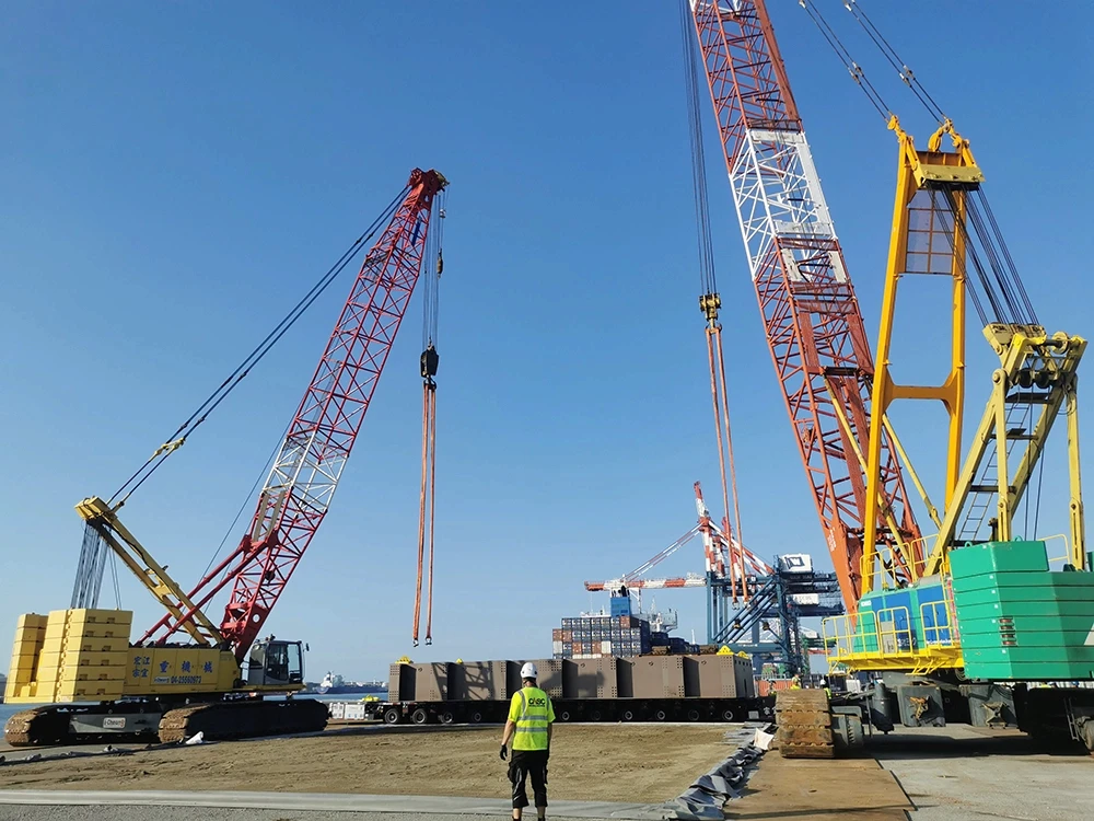 CASC employee overseeing quayside heavy lifting operation with multiple crawler cranes