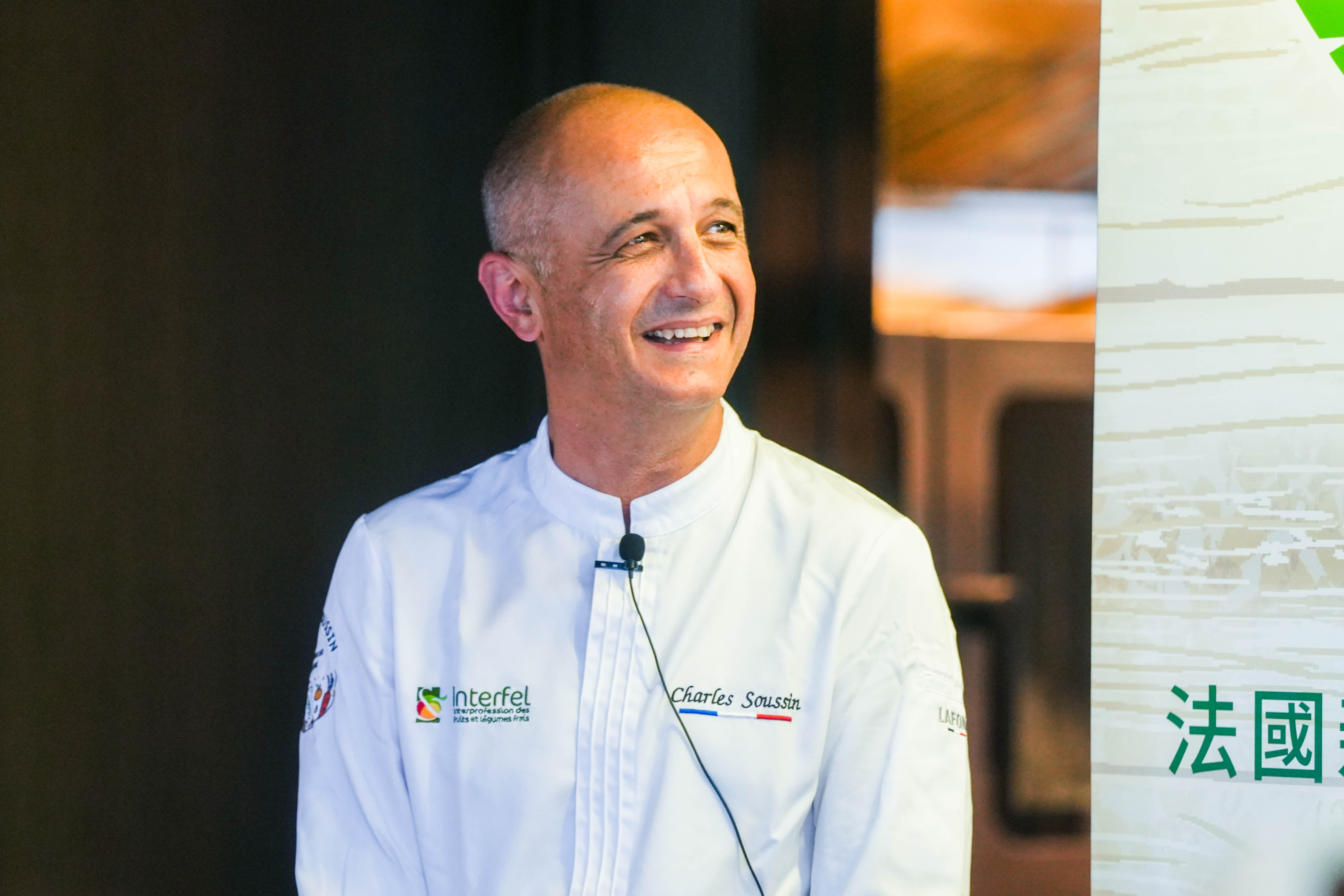 woman in blue tank top standing beside white wall