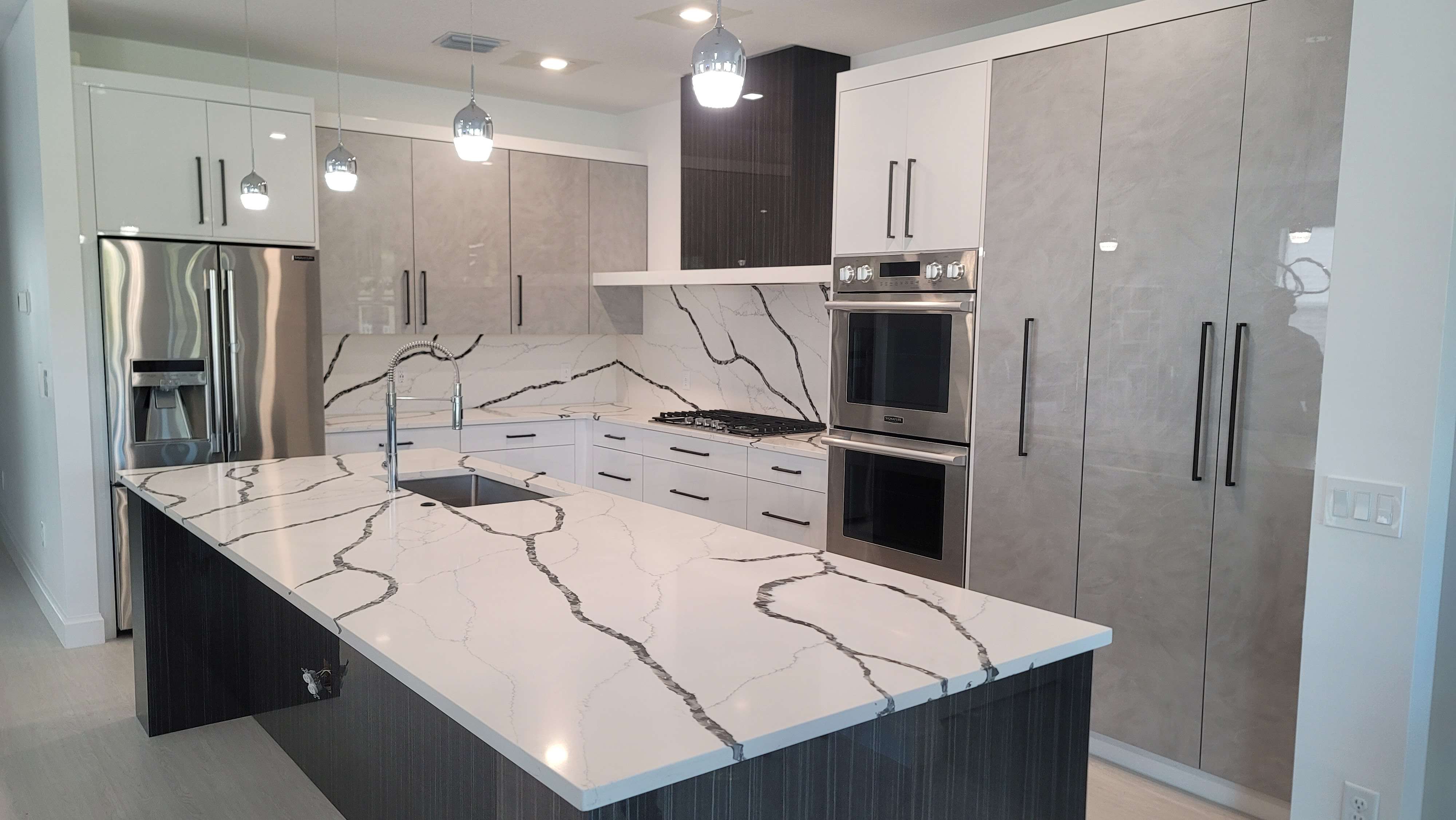 Contemporary Kitchen with High Gloss Cabinets, Calacatta Laza Night Countertops,  perfect vein matching