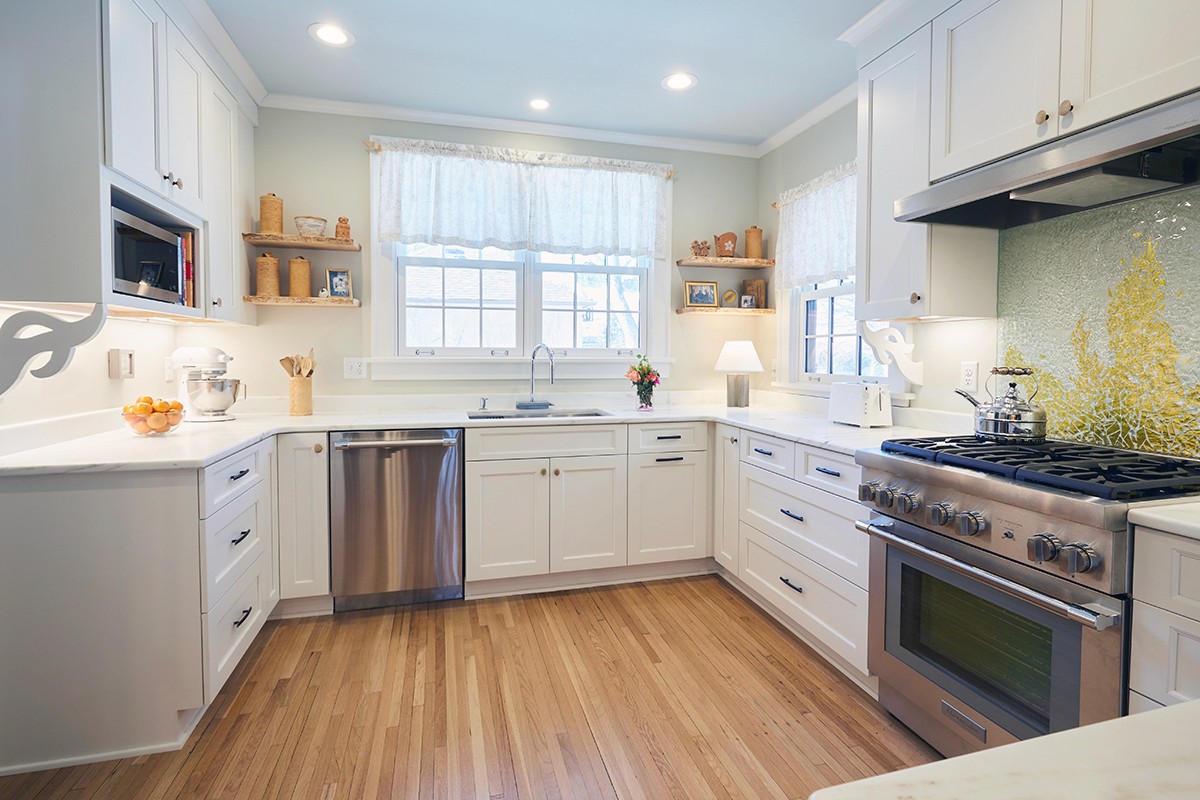 White Shaker kitchen with marble counters and stainless gas range, Linden Hills