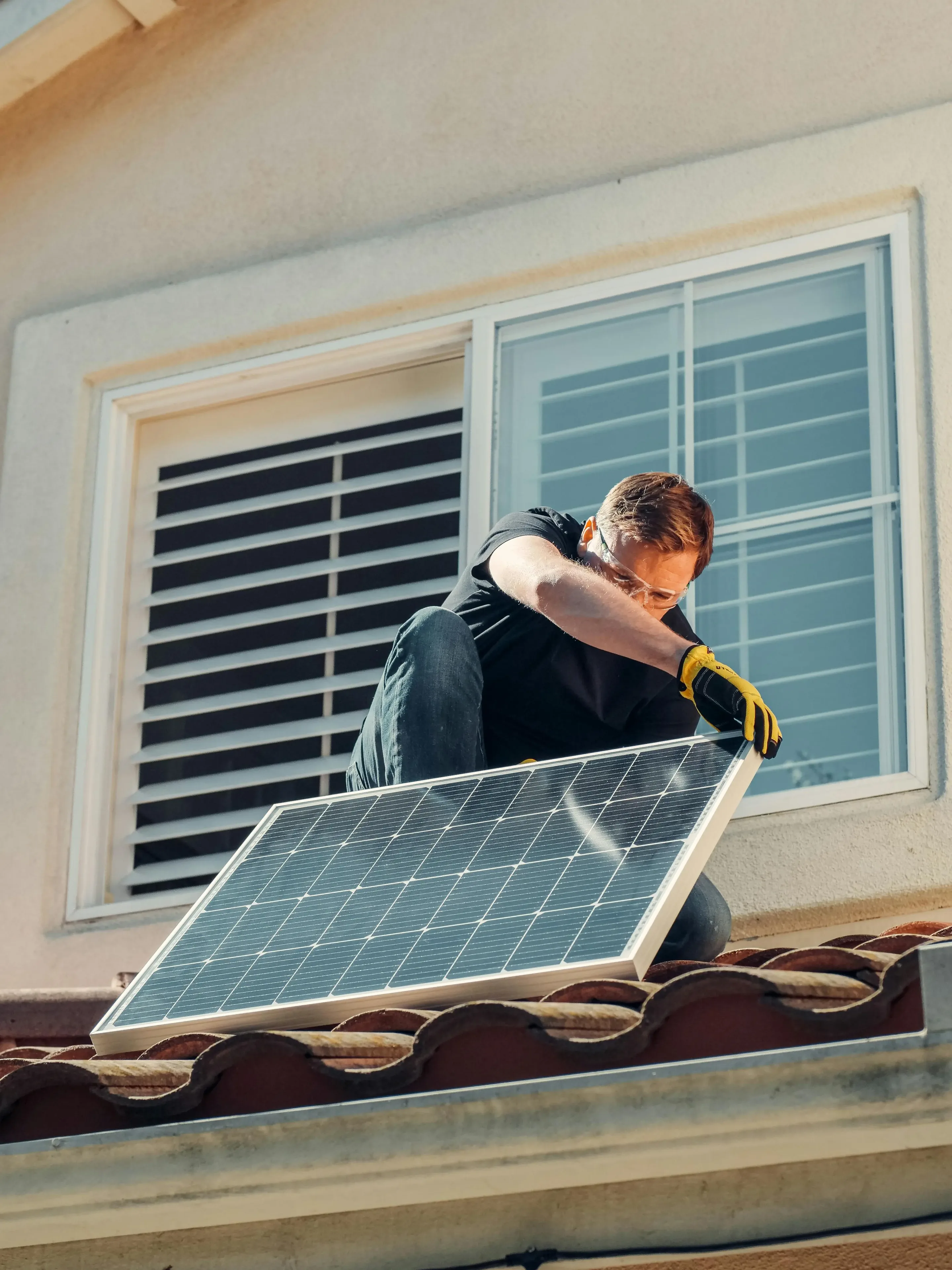 Certified technician installing a residential solar energy system