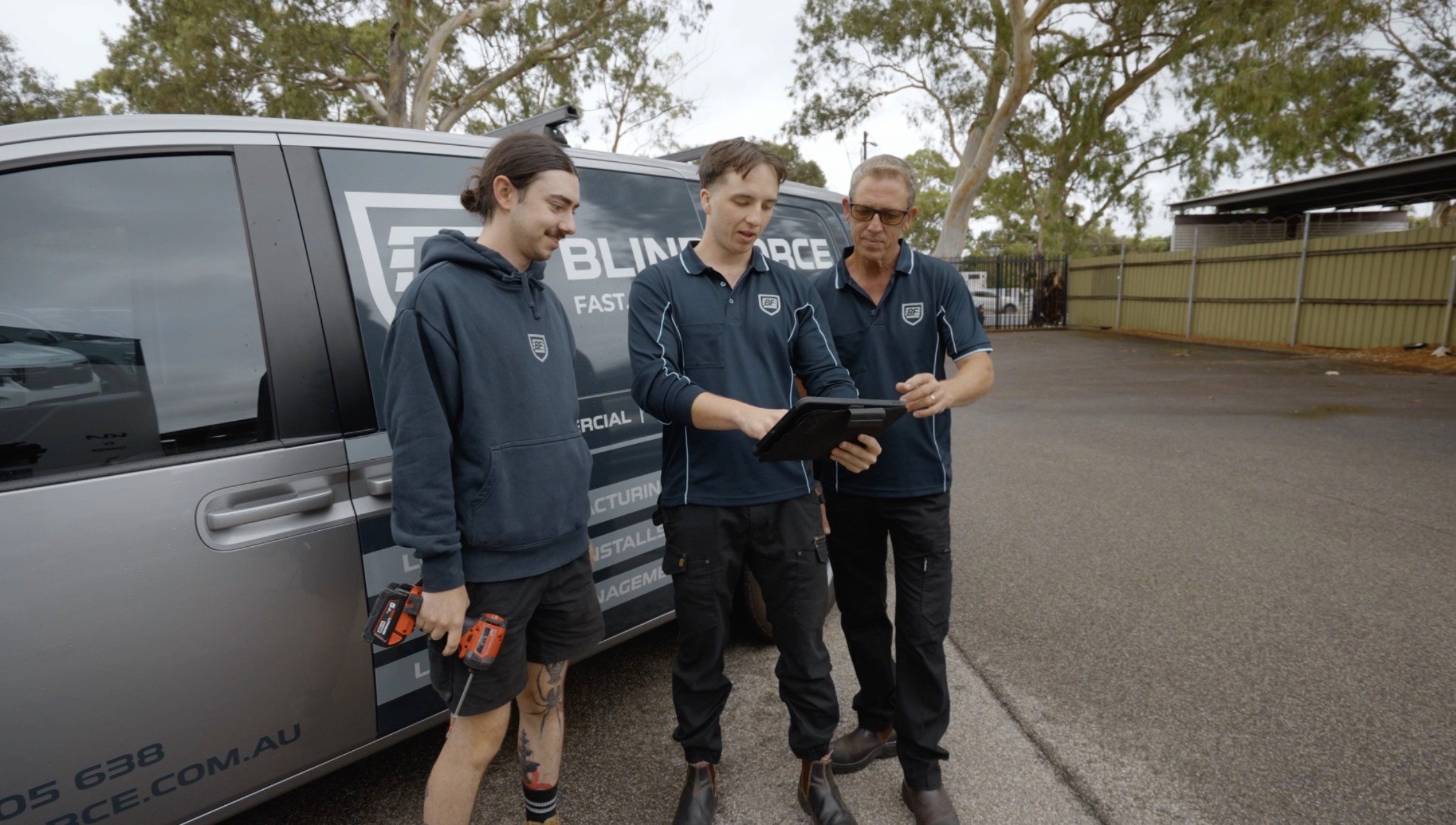 Blind Force technicians checking drawings and specifications on tablet