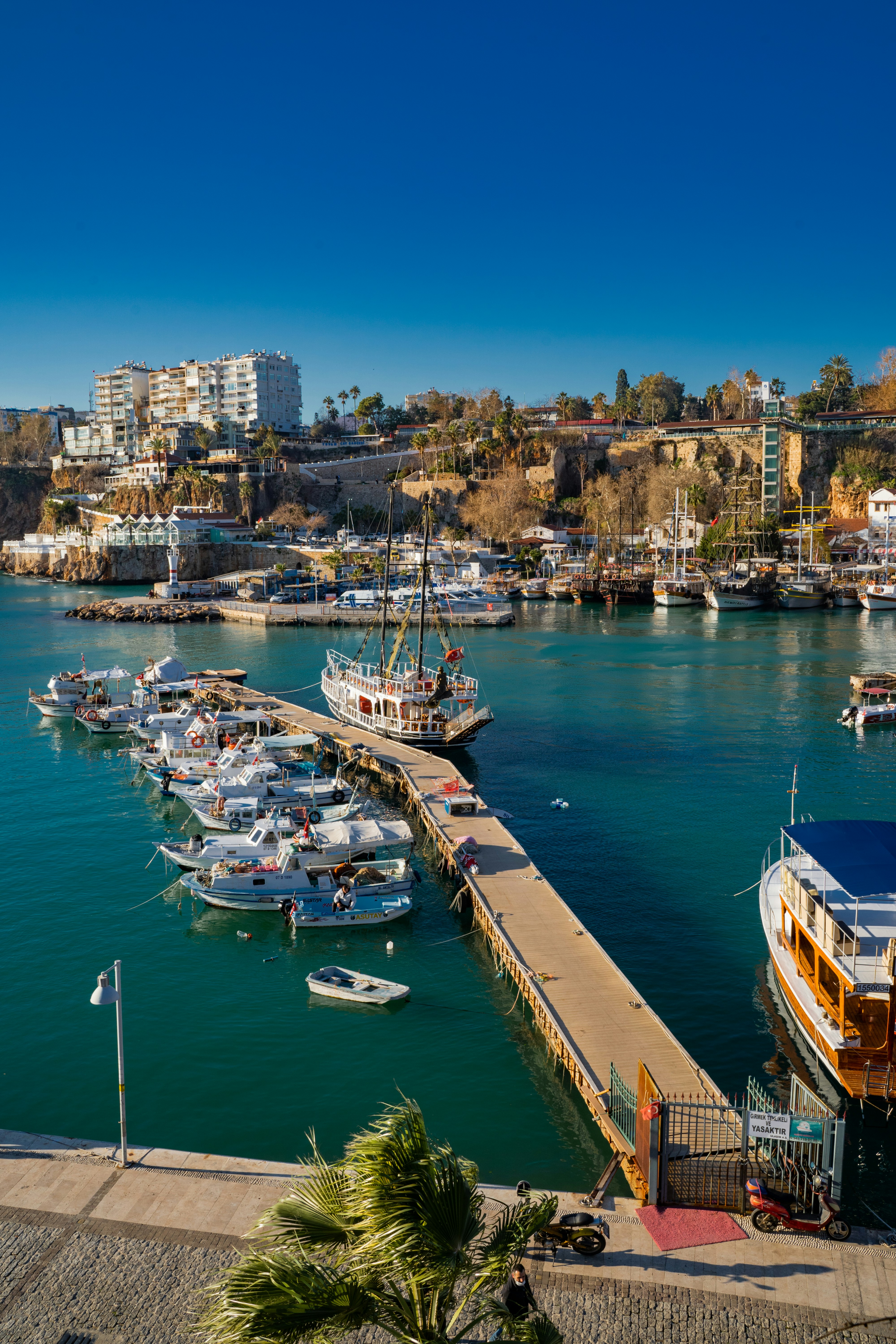 a harbor filled with lots of boats next to a city