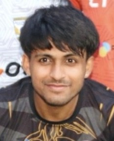 man in gray crew neck t-shirt and gray shorts sitting on basketball court