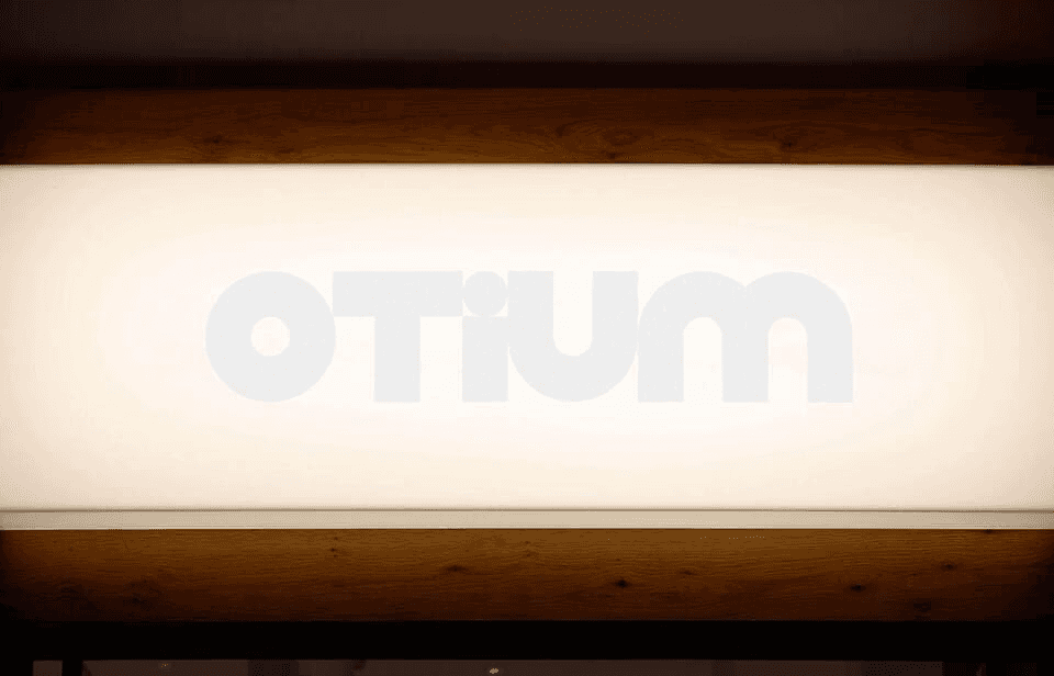 OTIUM logo on a light-emitting display