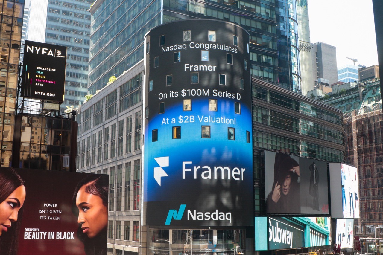 Framer celebrated on Nasdaq billboard in Times Square after $100M Series D funding, highlighting growth and trust in the no-code web platform.